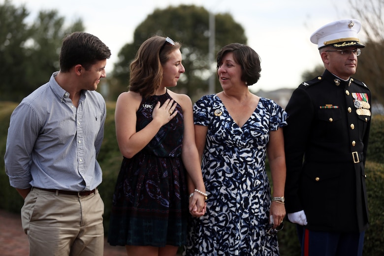 Col. Yori R. Escalante stands beside his family upon being retired from the Marine Corps after a ceremony at Marine Corps Base Camp Lejeune, Oct. 14. Col. Yori R. Escalante, deputy commander of Marine Corps Installation East - Marine Corps Base Camp Lejeune, retired today after 30 years of faithful and dedicated service to the Marine Corps. (U.S. Marine Corps photo by Pfc. Juan Madrigal/Released)
