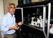 Dr. Benji Maruyama, a senior materials research engineer at the Air Force Research Laboratory’s Functional Materials Division, stands by the AFRL’s Autonomous Research System, which uses artificial intelligence to design, execute and analyze experiments at a pace much faster than traditional scientific research methods. The robotic research machine is revolutionizing materials science research and demonstrates the benefits of human-machine interaction for rapid advancement and development of knowledge today. (U.S. Air Force photo/Marisa Novobilski)