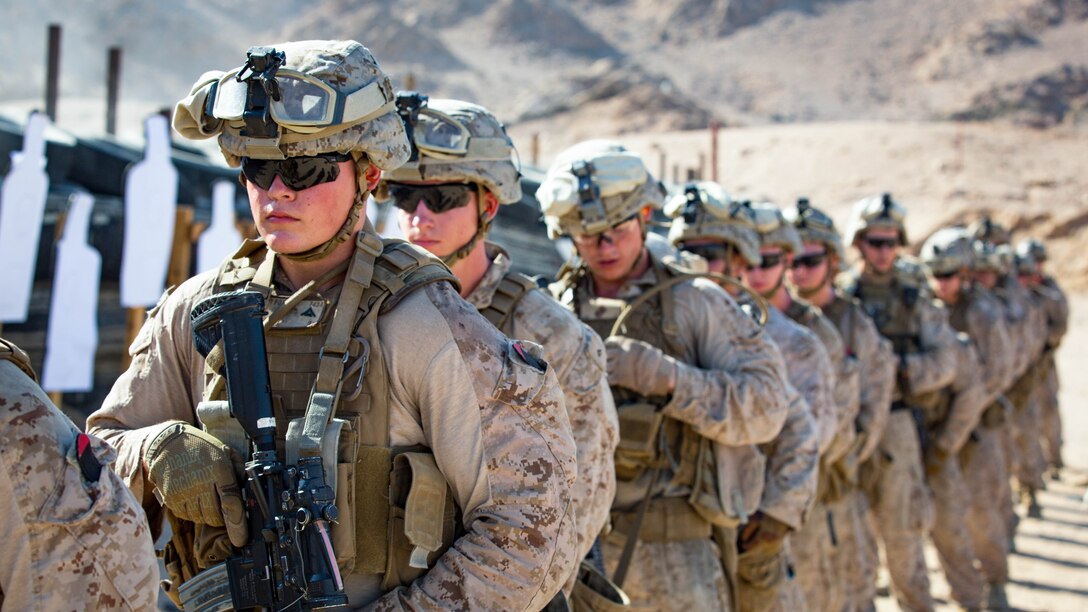 U.S. Marines with weapons platoon, Company F, 2nd Battalion, 7th Marine Regiment, Special Purpose Marine Air - Ground Task Force - Crisis Response - Central Command, stand on-line while conducting a live - fire range during Mission Rehearsal Exercise 2016 near the southern border of the Hashemite Kingdom of Jordan,  Sept. 11, 2016. The MRX is a collective training event where the MAGTF elements collaborate to refine individual and cooperative capabilities. SPMAGTF - CR – CC is a self-sustaining expeditionary unit, designed to provide a broad range of crisis response capabilities throughout the Central Command area of responsibility, using organic aviation, logistical, and ground combat assets, to include embassy reinforcement and tactical recovery of aircraft and personnel. 