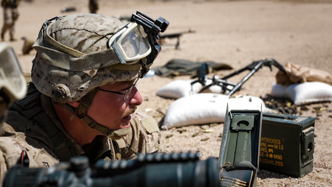 U.S. Marine Corps Lance Cpl. Heston Farrelly, a machine gunner with weapons platoon, Company F, 2nd Battalion, 7th Marine Regiment, Special Purpose Marine Air - Ground Task Force - Crisis Response - Central Command, looks down range during a live - fire range during Mission Rehearsal Exercise 2016 near the southern border of the Hashemite Kingdom of Jordan,  Sept. 11, 2016. The MRX is a collective training event where the MAGTF elements collaborate to refine individual and cooperative capabilities. SPMAGTF - CR – CC is a self-sustaining expeditionary unit, designed to provide a broad range of crisis response capabilities throughout the Central Command area of responsibility, using organic aviation, logistical, and ground combat assets, to include embassy reinforcement and tactical recovery of aircraft and personnel. 