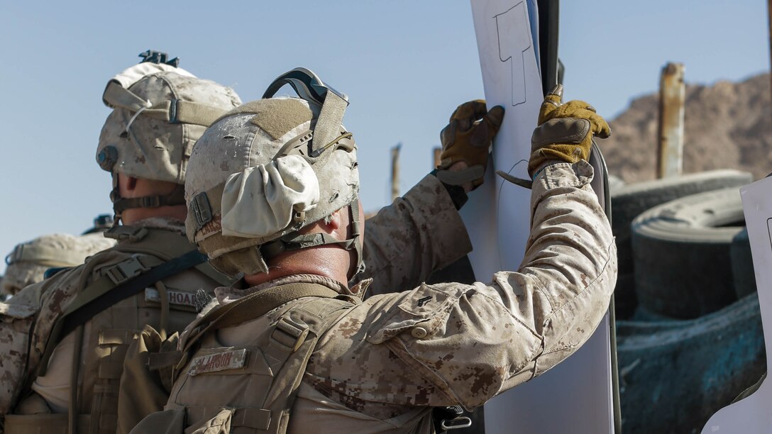 U.S. Marines with weapons platoon, Company F, 2nd Battalion, 7th Marine Regiment, Special Purpose Marine Air - Ground Task Force - Crisis Response - Central Command, place new targets while conducting a live - fire range during Mission Rehearsal Exercise 2016 near the southern border of the Hashemite Kingdom of Jordan,  Sept. 11, 2016. The MRX is a collective training event where the MAGTF elements collaborate to refine individual and cooperative capabilities. SPMAGTF - CR – CC is a self-sustaining expeditionary unit, designed to provide a broad range of crisis response capabilities throughout the Central Command area of responsibility, using organic aviation, logistical, and ground combat assets, to include embassy reinforcement and tactical recovery of aircraft and personnel. 