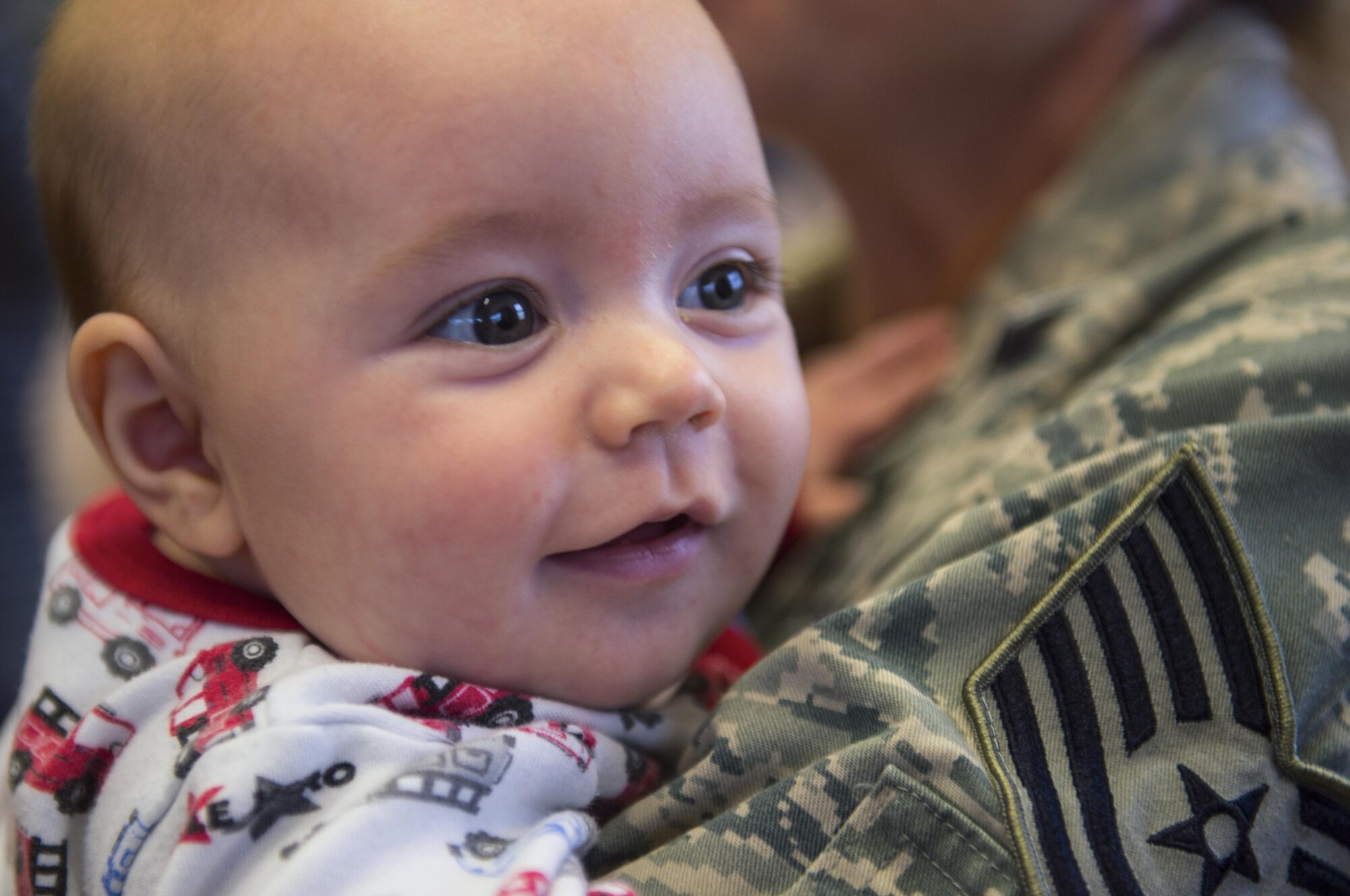 An infant awaits meeting his father for the first time during the 606th Air Control Squadron’s homecoming to Spangdahlem Air Base, Germany, Oct. 20, 2016. The squadron provided support to the 727th Expeditionary Air Control Squadron, also known as Kingpin, which is composed of U.S. and coalition partners who monitor activity in the airspace surrounding their area of responsibility. (U.S. Air Force photo by Senior Airman Dawn M. Weber)