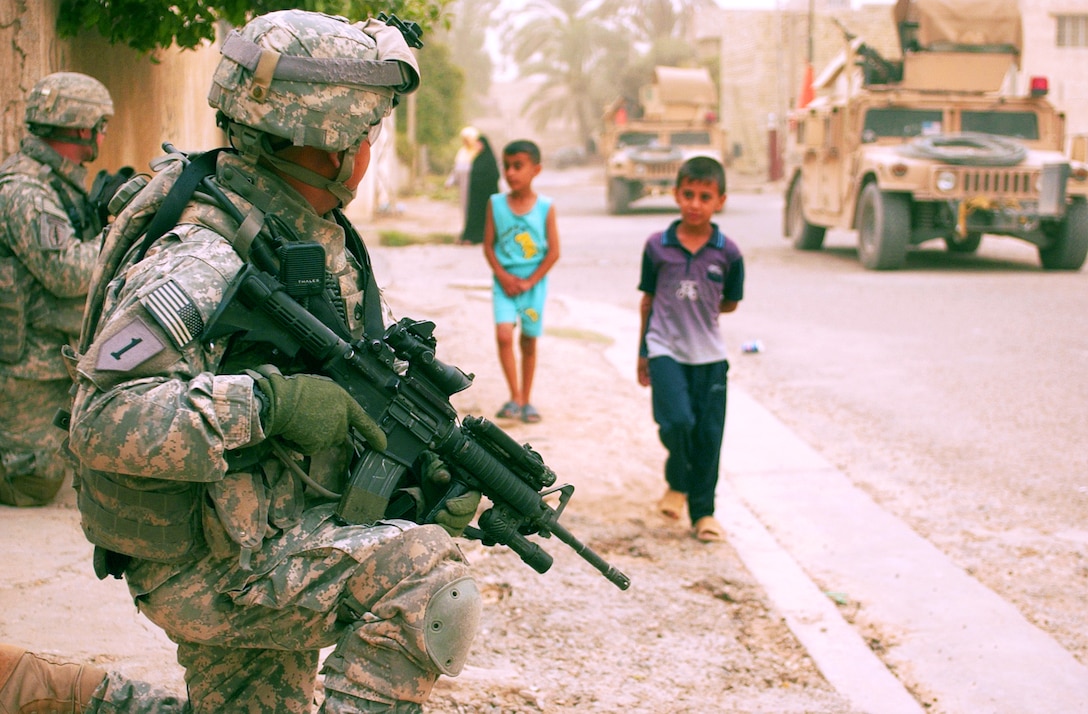 U.S. Army Soldiers provides security during a mission in Yarmouk, Iraq, July 2007. The Soldiers are with Bravo Battery, 2nd Battalion, 32nd Field Artillery, 4th Brigade, 1st Infantry Division out of Fort Riley, Kansas.