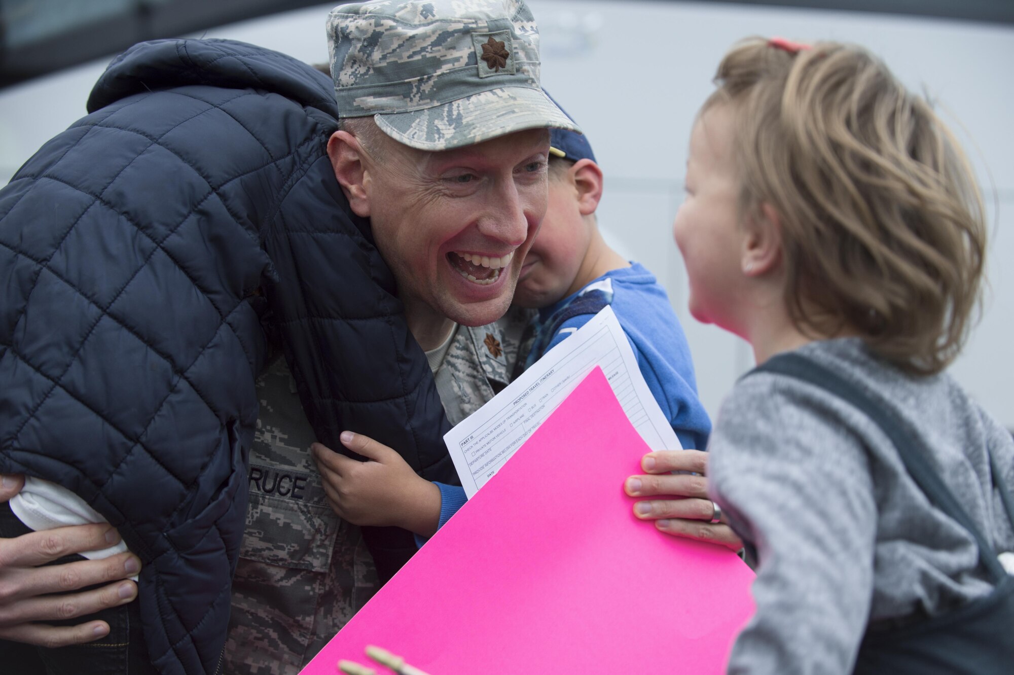 An Airman from the 606th Air Control Squadron reunites with his children during the squadron’s homecoming at Spangdahlem Air Base, Germany, Oct. 20, 2016. The unit provides daily command and control to the 480th Fighter Squadron, in addition to the occasional control of E-3A Sentry Airborne Warning and Control Systems from NATO Air Base Geilenkirchen, Germany, and visiting aircraft from around the U.S. Air Forces in Europe's scope of operations. (U.S. Air Force photo by Senior Airman Dawn M. Weber)