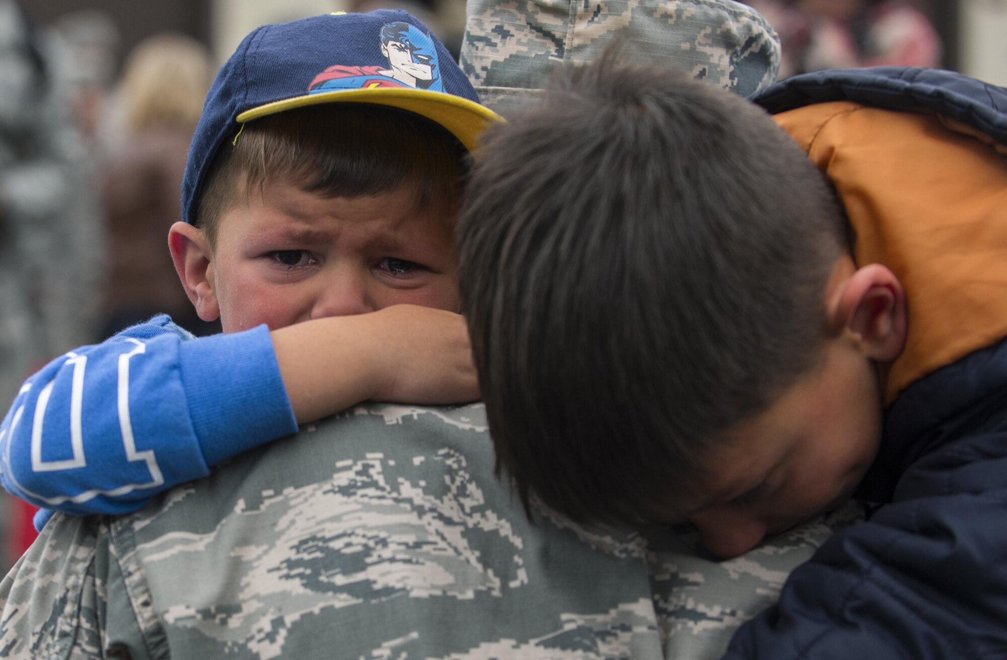 Two boys hug their father, an Airman assigned to the 606th Air Control Squadron, during the squadron’s homecoming to Spangdahlem Air Base, Germany, Oct. 20, 2016. The squadron’s return took place in advance of its upcoming relocation from Spangdahlem to Aviano Air Base, Italy, in 2017 as part of the European Infrastructure Consolidation plan. (U.S. Air Force photo by Senior Airman Dawn M. Weber)