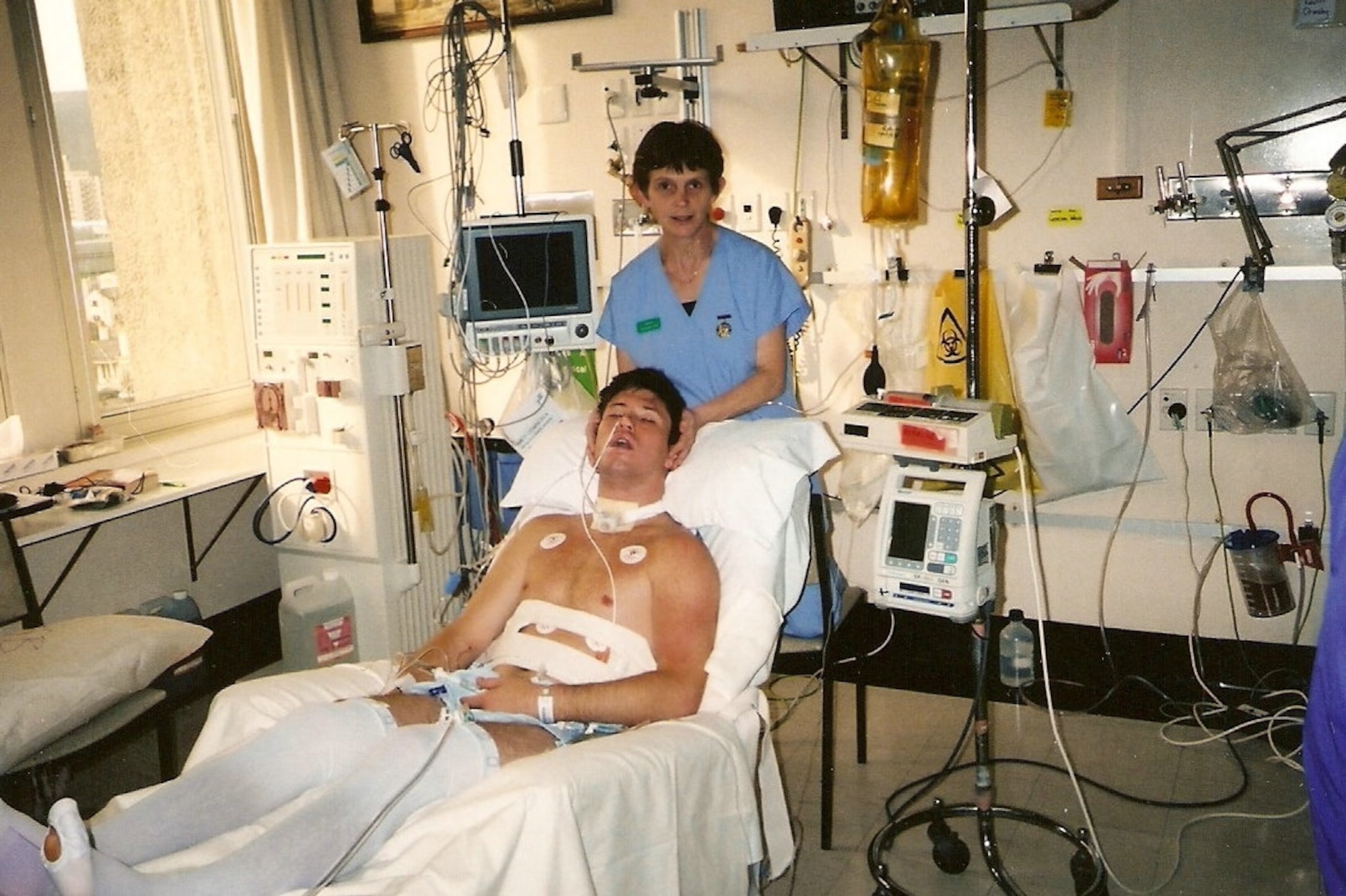 A nurse holds up Kevin Ormsby’s head at a hospital in New Zealand. Ormsby was found unconscious by members of the group he was skiing with after an accident on July 29, 2002. (Courtesy Photo)