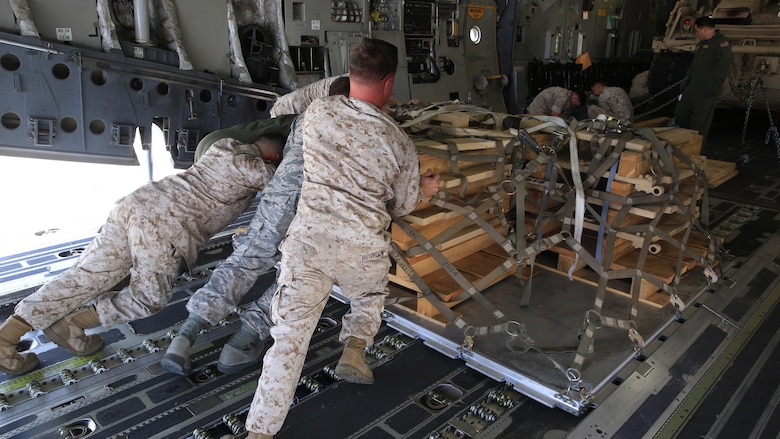 U.S. Marines and Airmen work hand-in-hand to load a pallet, filled with an M-88A2 HERCULES’ armored side skirts and front winch aboard the C-17 Globemaster III at March Air Force Reserves Base, Calif., Oct. 14, 2016. The C-17 flew to Marine Corps Air Ground Combat Center Twentynine Palms, Calif., to deliver the M-88A2 recovery vehicle for use by Combat Logistics Company 13.