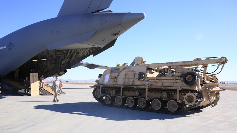 U.S. Marines and Airmen unload the M-88A2 HERCULES at Marine Corps Air Ground Combat Center Twentynine Palms, Calif., Oct. 14, 2016. Transporting the M-88A2 from March Air Force Reserves Base, Calif., to Combat Logistics Company 13 in Twentynine Palms, helped the aircrew for the C-17 Globemaster III meet quarterly requirements.