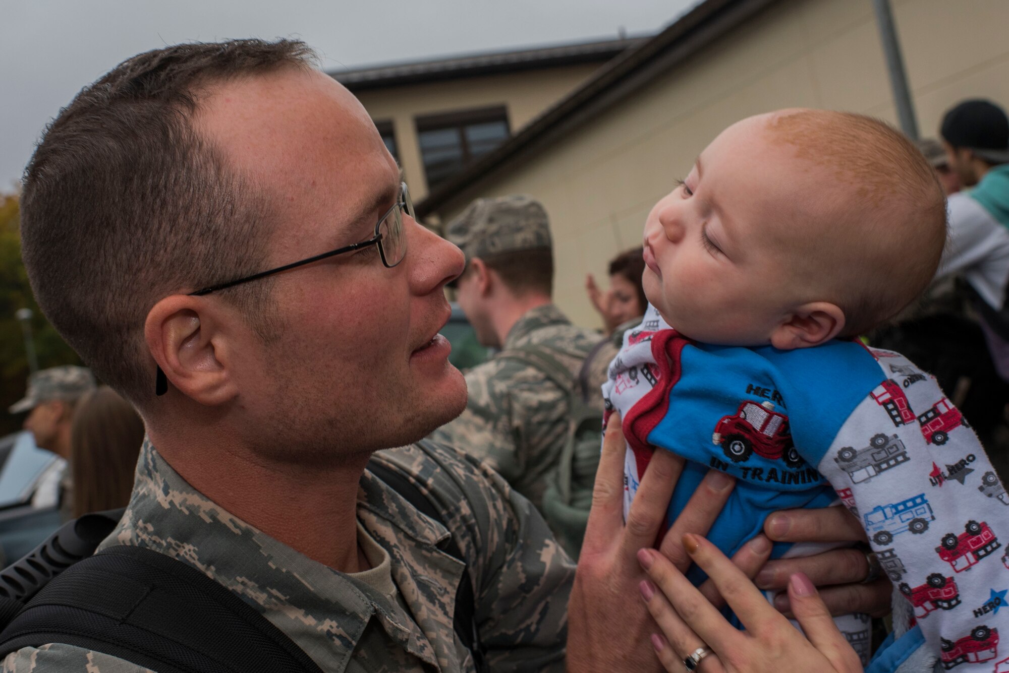 An Airman assigned to the 606th Air Control Squadron holds his infant son, born during his deployment, upon the 606th ACS' return to their squadron at Spangdahlem Air Base, Germany, Oct. 20, 2016. Nearly 200 Airmen assigned to the 606th ACS returned, from a six-month rotational deployment to Southwest Asia in support of Operations Freedom’s Sentinel and Inherent Resolve. (U.S. Air Force photo by Staff Sgt. Joe W. McFadden)