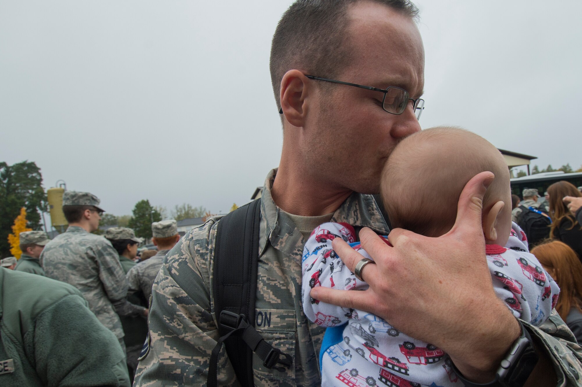 An Airman assigned to the 606th Air Control Squadron kisses his infant son, born during his deployment, upon the 606th ACS' return to their squadron at Spangdahlem Air Base, Germany, Oct. 20, 2016. Nearly 200 Airmen assigned to the 606th ACS returned, from a six-month rotational deployment to Southwest Asia in support of Operations Freedom’s Sentinel and Inherent Resolve. (U.S. Air Force photo by Staff Sgt. Joe W. McFadden)