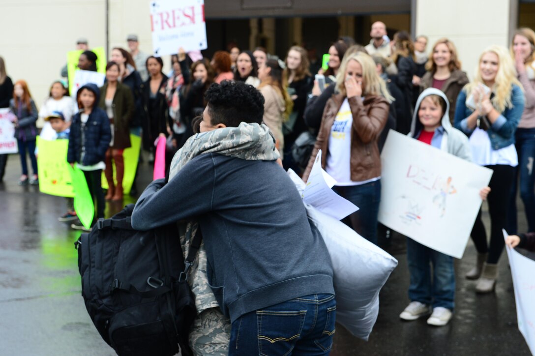 An Airman assigned to the 606th Air Control Squadron is embraces a family member upon returning to Spangdahlem Air Base, Germany, Oct. 20, 2016, from a six-month rotational deployment to Southwest Asia, as other families watch. The squadron provided support to the 727th Expeditionary Air Control Squadron, also known as Kingpin, which is composed of U.S. and coalition partners who monitor activity in the airspace surrounding their area of responsibility. (U.S. Air Force photo by Senior Airman Joshua R. M. Dewberry)
