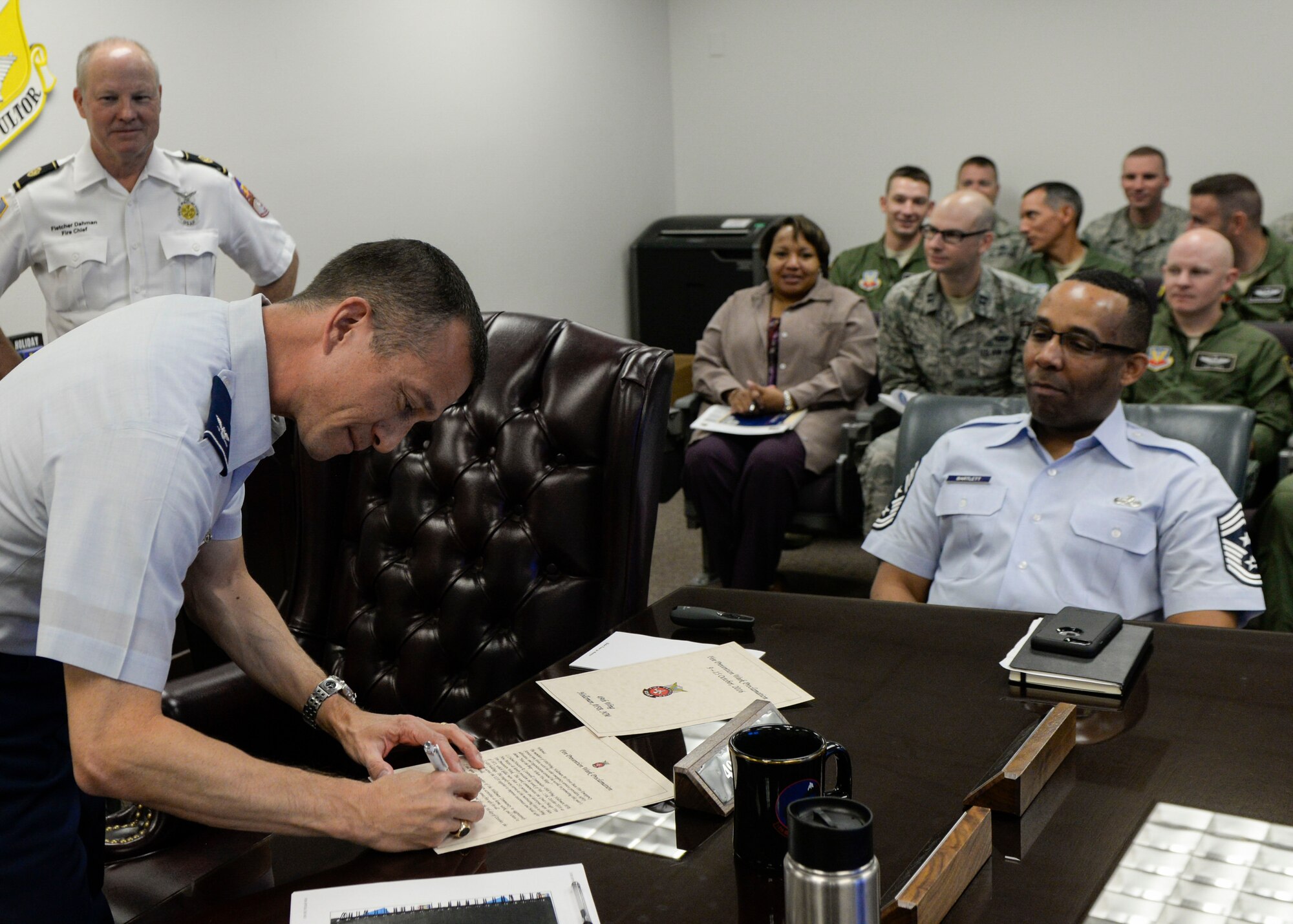 Col. Houston Cantwell, the 49th Wing Commander, signs the Fire Prevention Week proclamation at Holloman Air Force Base, N.M. on Oct. 9, 2016. Holloman Air Force Base’s Fire Prevention Week is annually practiced in commemoration of the great Chicago Fire of 1871. Members with the 49th Civil Engineer Squadron Fire Protection Flight performed fire drills, and educated people on proper use of a fire extinguisher and the importance of changing out batteries in smoke alarms every six months. (U.S. Air Force photo by Airman 1st Class Alexis P. Docherty)