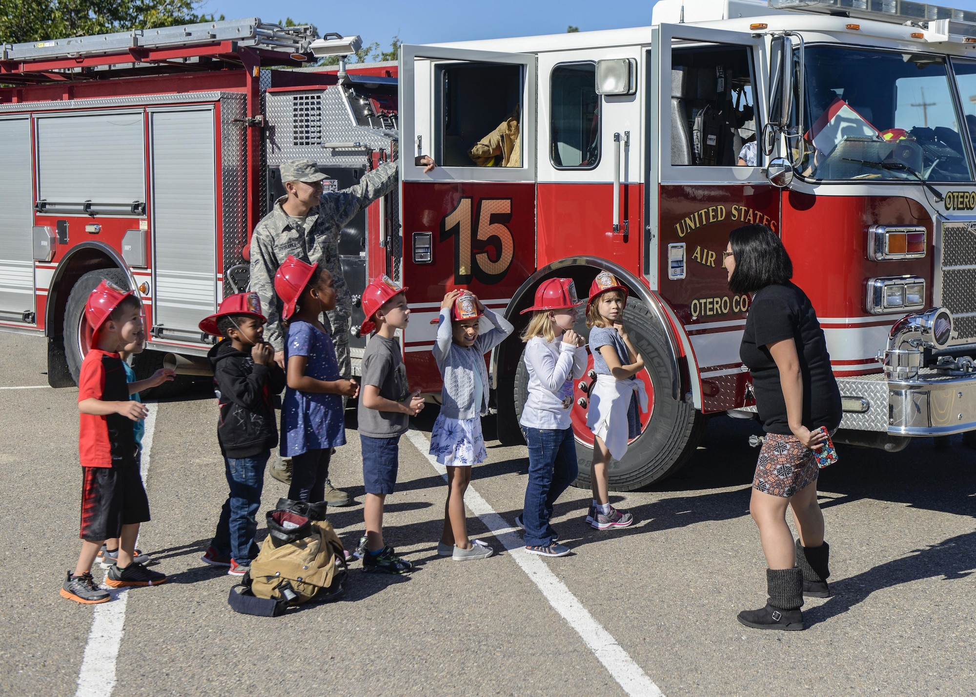 A group of children take turns exploring a fire truck at Holloman Air Force Base’s elementary school as part of the base’s annual Fire Prevention Week, Oct. 14, 2016 at Holloman AFB, N.M. Holloman AFB firefighters visited the base’s elementary and middle schools throughout the week, to teach students about the importance of practicing fire safety. (U.S. Air Force photo by Airman 1st Class Alexis P. Docherty) 