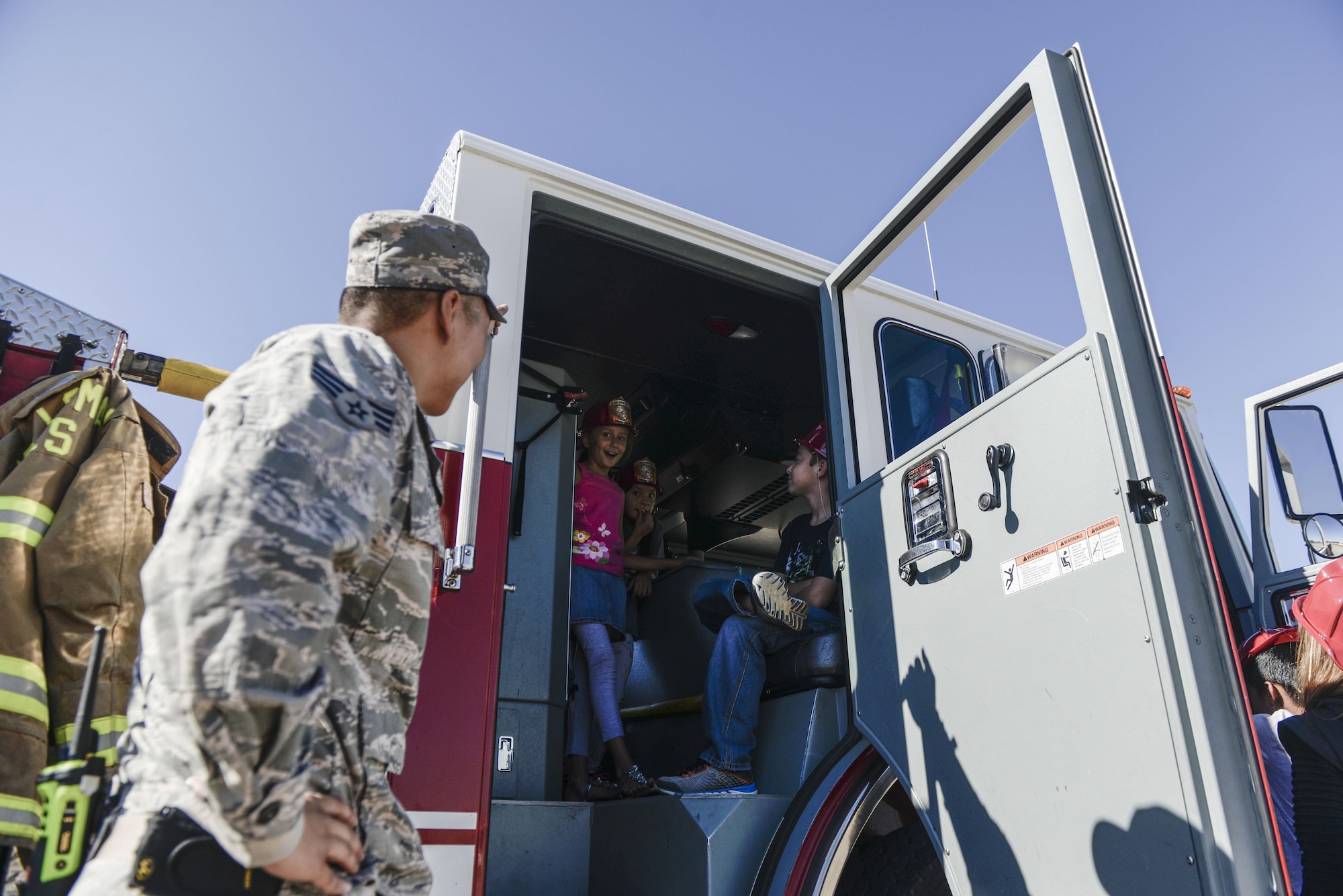 A group of children sit inside a fire truck at Holloman Air Force Base’s elementary school as part of the base’s annual Fire Prevention Week, Oct. 11, 2016 at Holloman Air Force Base, N.M. Sparky the Fire Dog and members with the 49th Civil Engineer Squadron Fire Protection Flight, educated students on fire safety and allowed them to explore two fire trucks. (U.S. Air Force photo by Airman 1st Class Alexis P. Docherty)