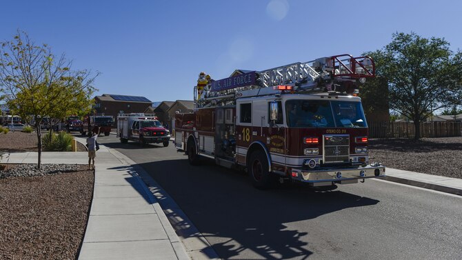 A child waves to an ambulance during Holloman Air Force Base’s annual Fire Prevention Week parade through the Soaring Heights community, Oct. 15, 2016 at Holloman AFB, N.M. Sparky the Fire Dog and members of the 49th Civil Engineer Squadron Fire Protection Flight drove through several base neighborhoods and gifted candy to children and families. (U.S. Air Force photo by Airman 1st Class Alexis P. Docherty) 