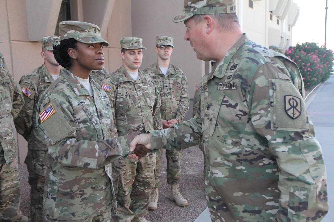 Colonel Paul Hettich, the rear commander of the 451st Expeditionary Sustainment Command, visited the 387th Human Resources detachment and recognized 1st Lieutenant LaShontonna Sipho, platoon leader of the detachment, and Sergeant First Class Telia Phoenix, platoon sergeant of the detachment, for their hard work. “You both have done a great job preparing Soldiers and I know this will be a successful deployment,” said Col. Hettich as he coined both women. This is the first deployment for Sipho and Phoenix who, combined, are the command team for the small postal detachment.