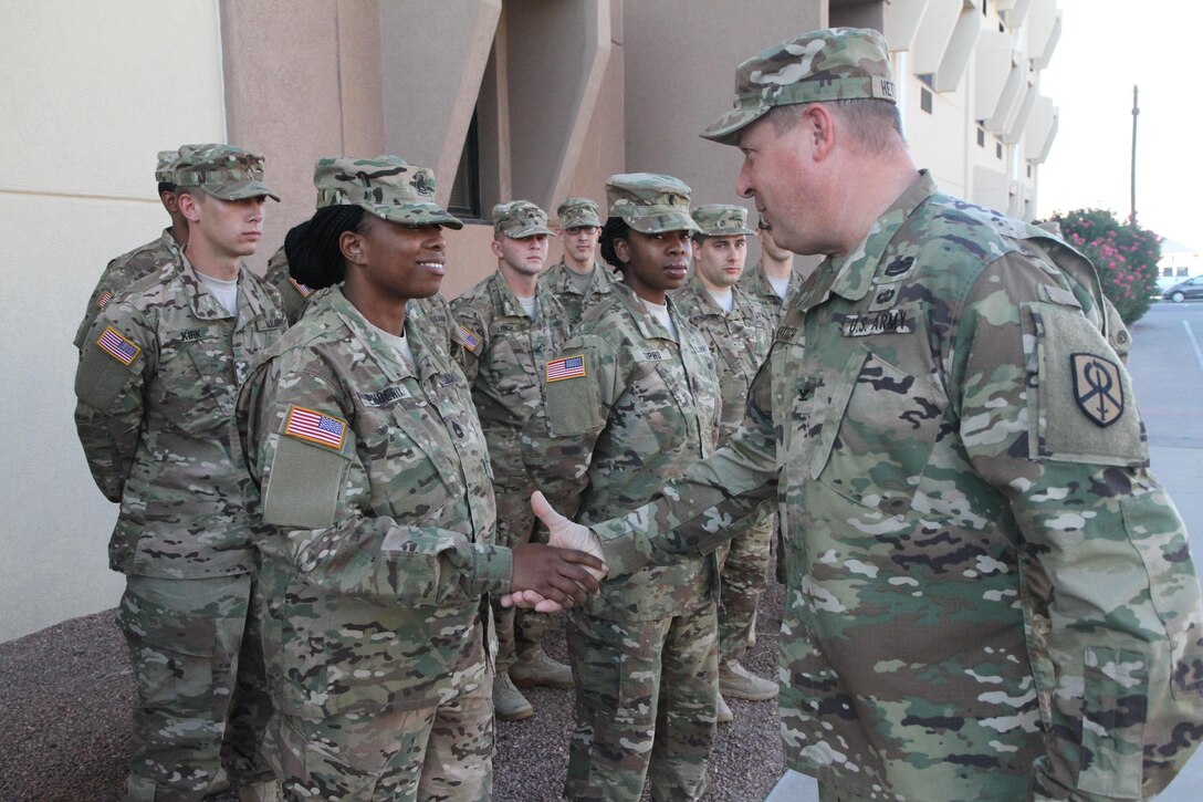 Colonel Paul Hettich, the rear commander of the 451st Expeditionary Sustainment Command, visited the 387th Human Resources detachment and recognized 1st Lieutenant LaShontonna Sipho, platoon leader of the detachment, and Sergeant First Class Telia Phoenix, platoon sergeant of the detachment, for their hard work. “You both have done a great job preparing Soldiers and I know this will be a successful deployment,” said Col. Hettich as he coined both women. This is the first deployment for Sipho and Phoenix who, combined, are the command team for the small postal detachment.