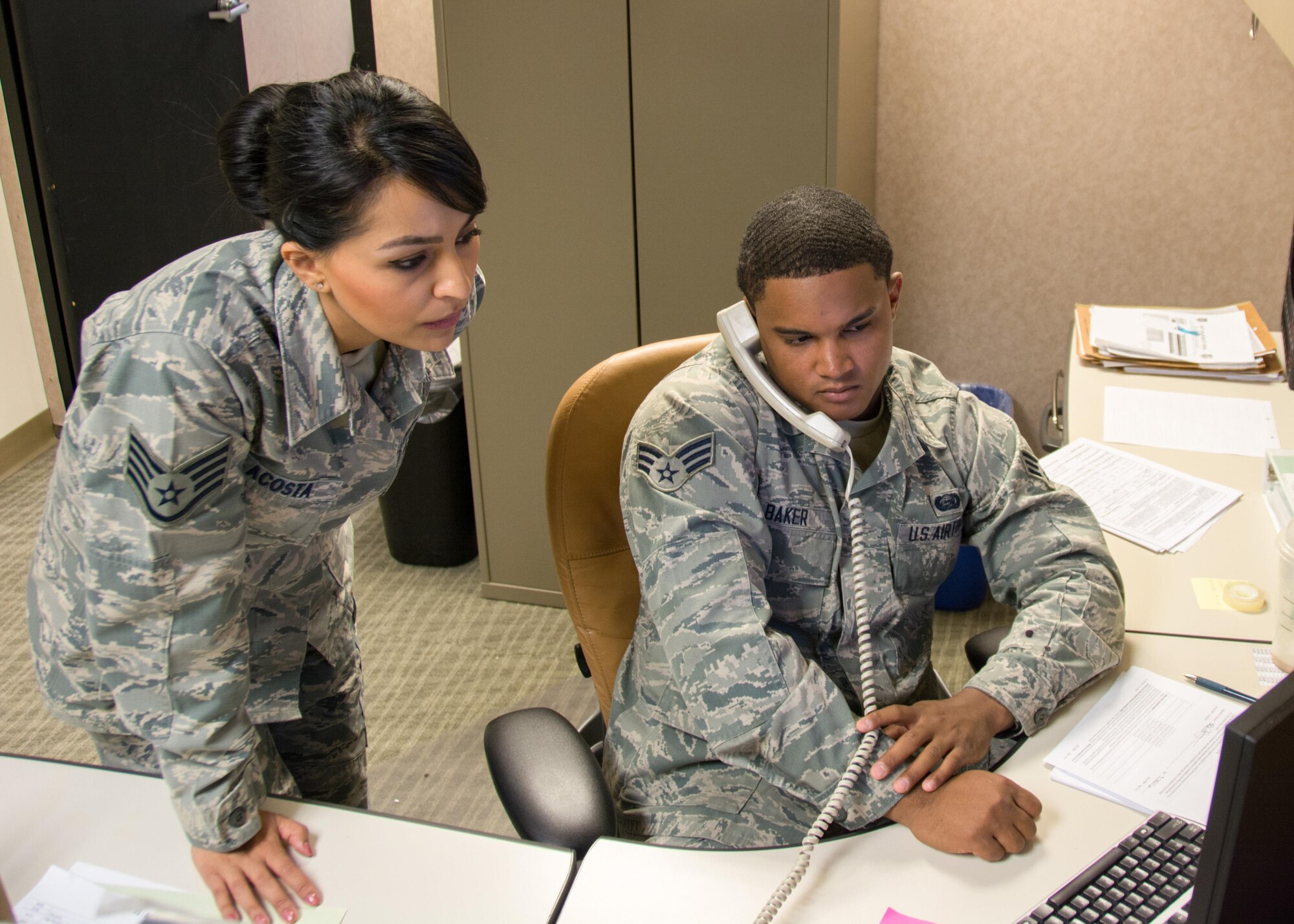 Staff Sgt. Candace Acosta and Senior Airman Kevin Baker, 349th Force Support Squadron personnelists, troubleshoot administrative issues during the Oct. 1st unit training assembly. (U.S. Air Force photo by Senior Master Sgt. Rachel Martinez)