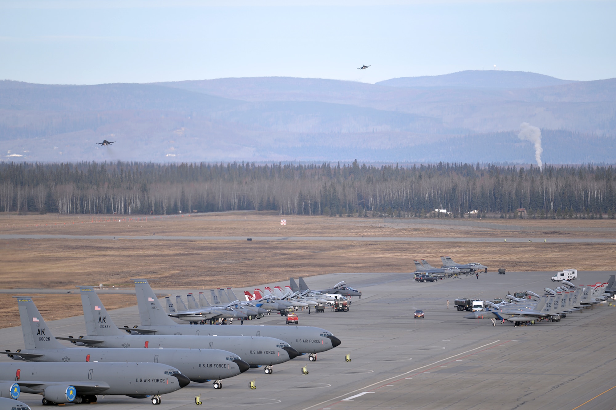 A variety of units aircraft and personnel gather in their ramp space as a pair of F-16 Fighting Falcons prepare to land at Eielson Air Force Base, Alaska, Oct. 10, 2016, after the first Red Flag-Alaska 17-1 combat training mission. Red Flag-Alaska is a Pacific Air Forces commander-directed field training exercise and is vital to maintaining peace and stability in the Indo-Asia-Pacific region. The F-16s are assigned to the 36th Fighter Squadron at Osan Air Base, South Korea. (U.S. Air Force photo/Master Sgt. Karen J. Tomasik)