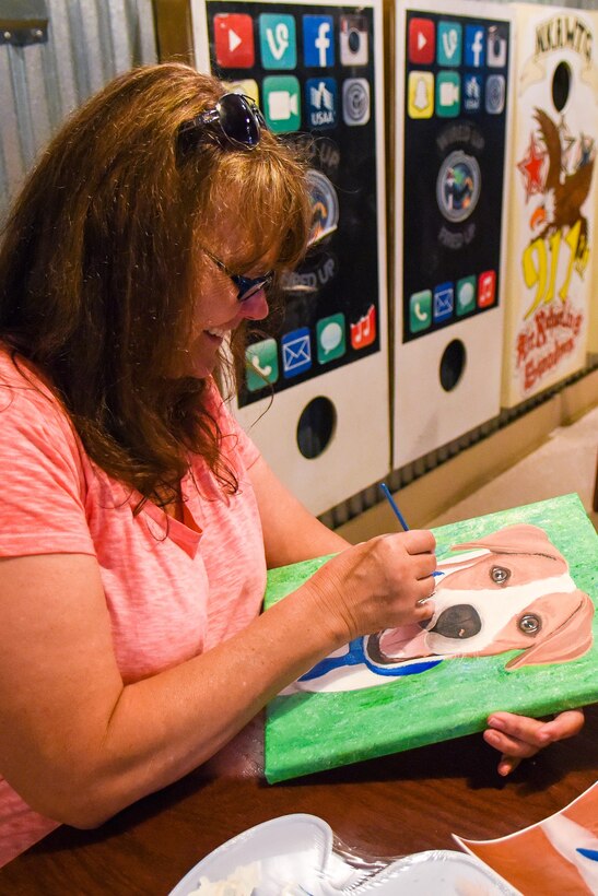 Tammy Amon, 4th Force Support Squadron visual information specialist, works on a painting of a dog, Sept. 13, 2016, at Seymour Johnson Air Force Base, North Carolina. Members of the club meet once a month at the Eagles Nest to work on personal or group projects. (U.S. Air Force photo by Airman Shawna L. Keyes)