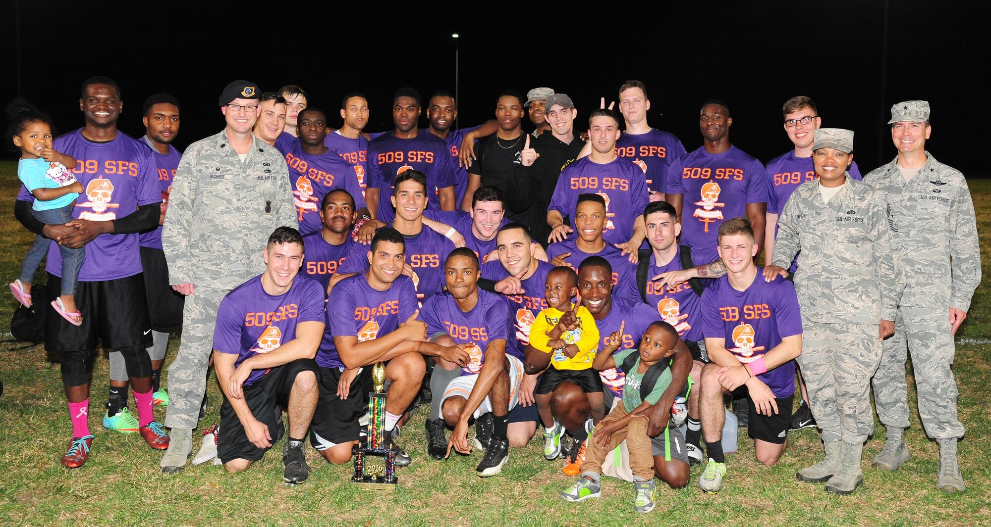 Members of the 509th Security Forces Squadron pose with the intramural flag-football championship trophy at Whiteman Air Force Base, Mo., Oct. 17, 2016. U.S. Air Force Brig. Gen. Paul W. Tibbets IV, the 509th Bomb Wing (BW) commander, and Chief Master Sgt. Melvina Smith, the 509th BW command chief, presented the team with the trophy. (U.S. Air Force photo by Senior Airman Joel Pfiester)