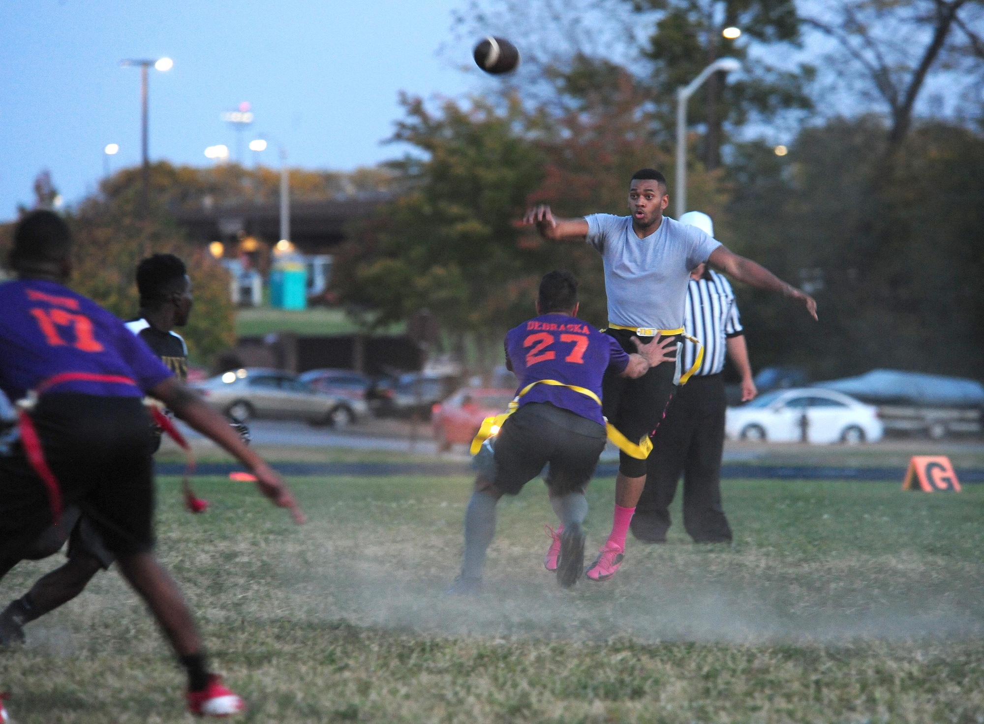 U.S. Air Force Senior Airman Isaac Moore, a weapons load crew member from the 509th Maintenance Group, throws a pass during the intramural flag-football championship game at Whiteman Air Force Base, Mo., Oct. 17, 2016. At halftime, the SFS was leading with a score of 16-0. (U.S. Air Force photo by Senior Airman Joel Pfiester)