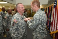 Sgt. David Lietz, left, public affairs specialist assigned to the 85th Support Command headquarters, receives an Army Commendation Medal during the command's battle assembly closing formation. Moments earlier Lietz received a promotion to sergeant reassigning him to the 318th Press Camp Headquarters.
(Photo by 2nd Lt. Jane Fox)
