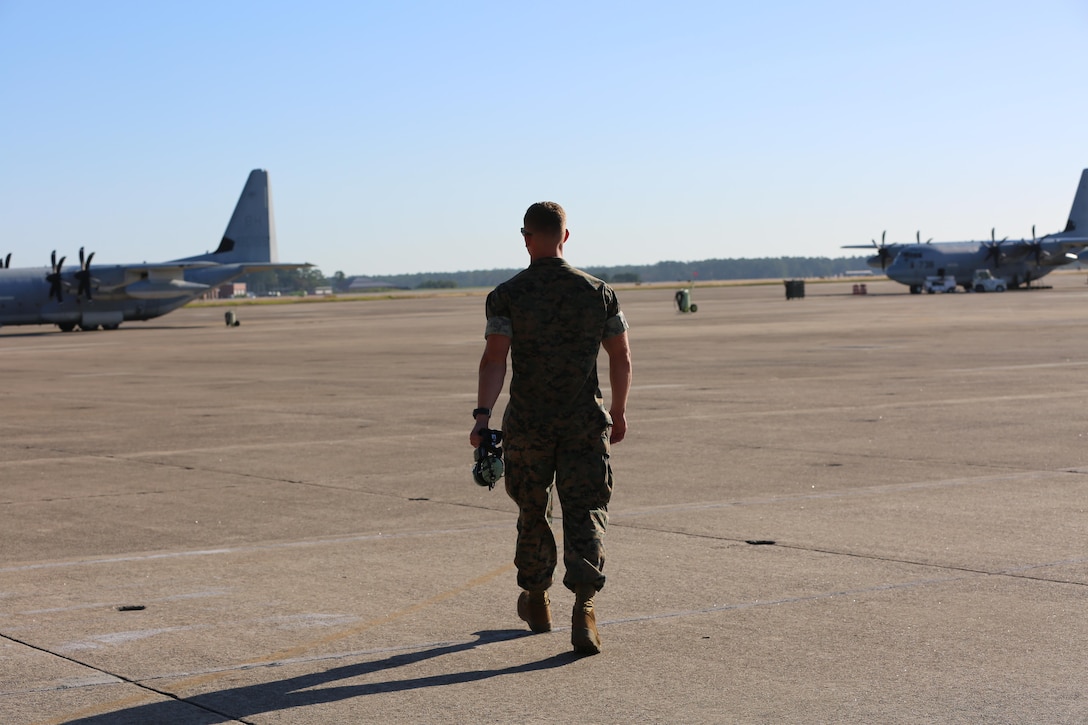 Lance Cpl. Charles Schneider walks towards a pair of Marine Corps KC-130J Hercules on the flight line aboard the Marine Corps Air Station Cherry Point, N.C., Oct. 18, 2016. Schneider has just recently completed his initial training to become a crew master with Marine Aerial Refueler Transport Squadron 252, 2nd Marine Aircraft Wing. “I’ve always been pretty mechanically inclined.” said Schneider. “I wanted to try something that very few people take advantage of. I’ve always loved airplanes, so I figured it would be really cool to work on them in the Marine Corps.” (U.S. Marine Corps photo by Lance Cpl. Mackenzie Gibson/Released)