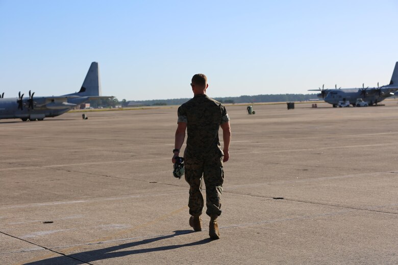 Lance Cpl. Charles Schneider walks towards a pair of Marine Corps KC-130J Hercules on the flight line aboard the Marine Corps Air Station Cherry Point, N.C., Oct. 18, 2016. Schneider has just recently completed his initial training to become a crew master with Marine Aerial Refueler Transport Squadron 252, 2nd Marine Aircraft Wing. “I’ve always been pretty mechanically inclined.” said Schneider. “I wanted to try something that very few people take advantage of. I’ve always loved airplanes, so I figured it would be really cool to work on them in the Marine Corps.” (U.S. Marine Corps photo by Lance Cpl. Mackenzie Gibson/Released)