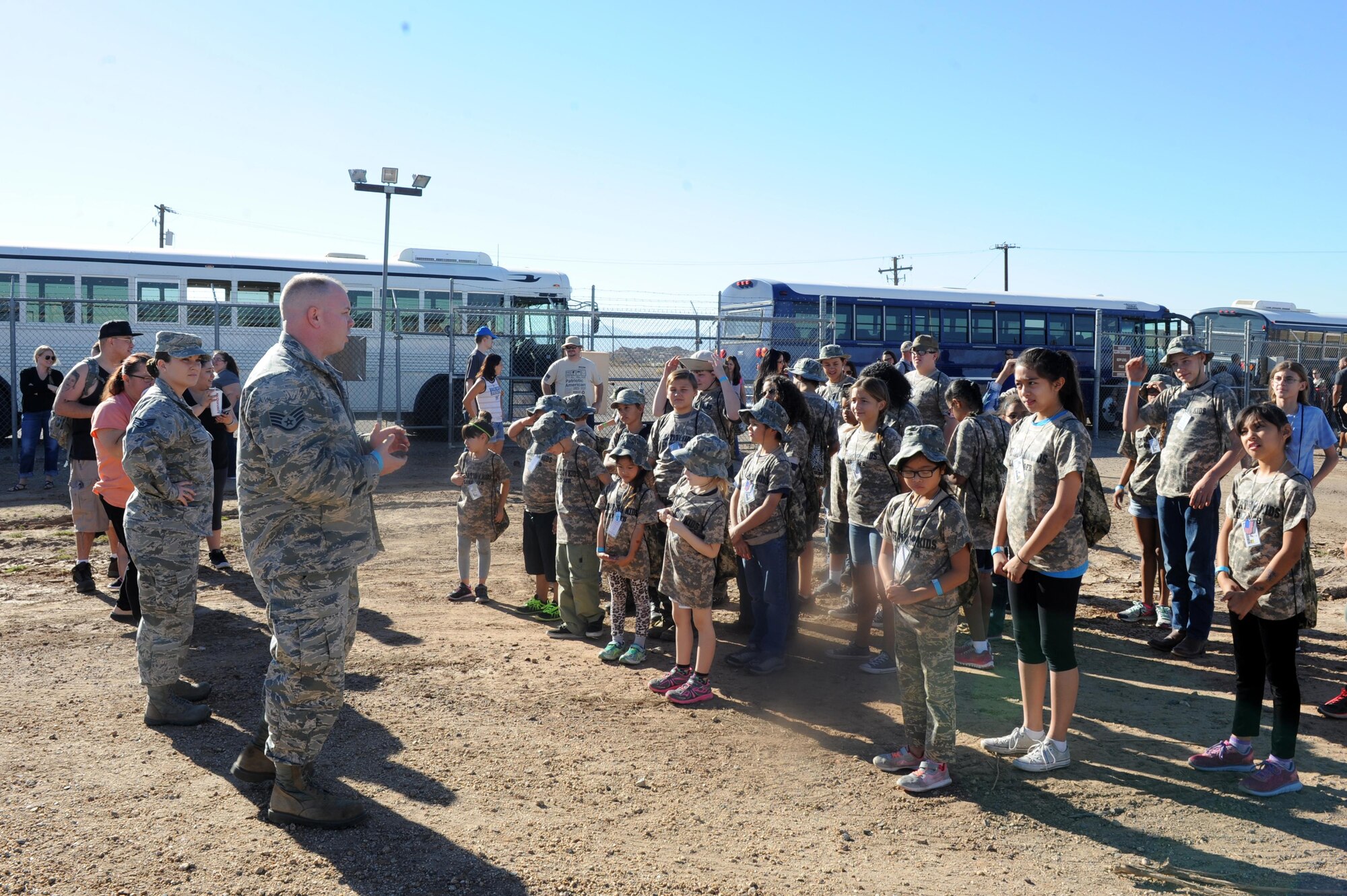 Staff Sgt. James McCoy, 56th Maintenance Group weapons system coordinator and Staff Sgt. Jessica Booth, 56th MXG weapons system coordinator, brief one of the four deployment teams during the Operation Kids event Oct. 15, at Luke Air Force Base, Ariz. After being assigned to teams, participants were transported to the ATSO area for training. (U.S. Air Force Photos by Airman 1st Class Pedro Mota)