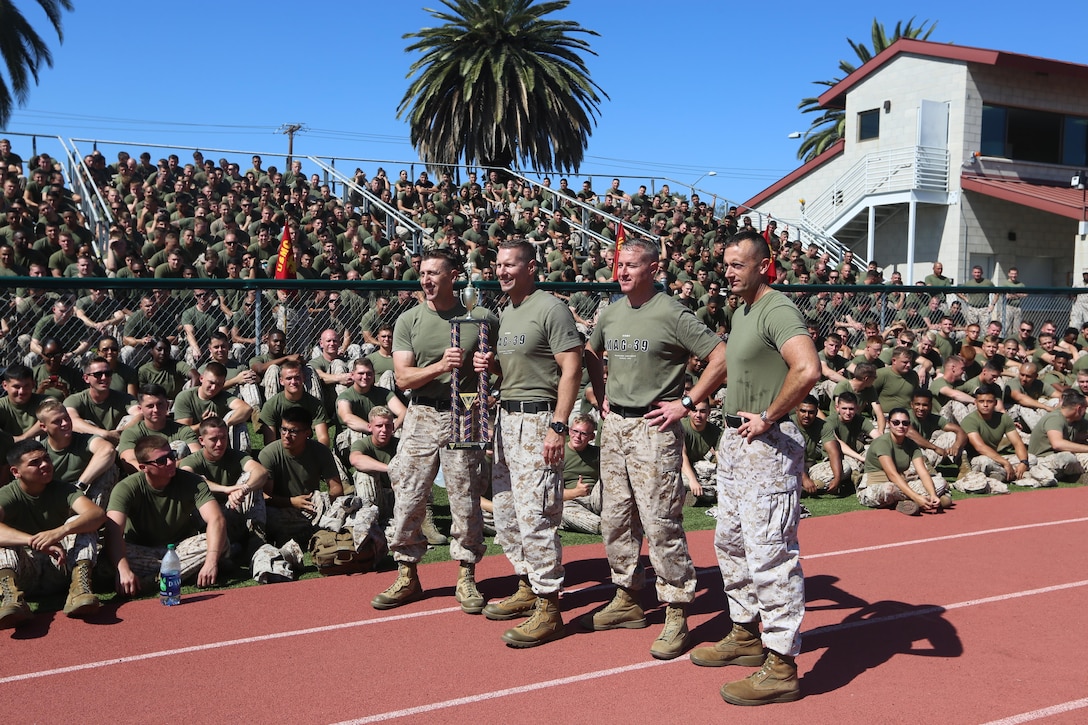 Col. Michael Borgschulte, left center, commanding officer of Marine Aircraft Group (MAG) 39; Sgt.Maj. Michael Pritchard, right center,  sergeant major of MAG-39; along with the leadership of Marine Aviation Logistics Squadron (MALS) 39, display the MAG-39 Warrior Games trophy at Marine Corps Base Camp Pendleton, Calif., Oct. 15. The Warrior Games consisted of a five-month competition between squadrons within MAG-39, culminating in a field meet, where each squadron competed to win points toward a trophy and grand prize of a 72-hour liberty period. (U.S. Marine Corps photo by Lance Cpl. Jacob Pruitt/Released)