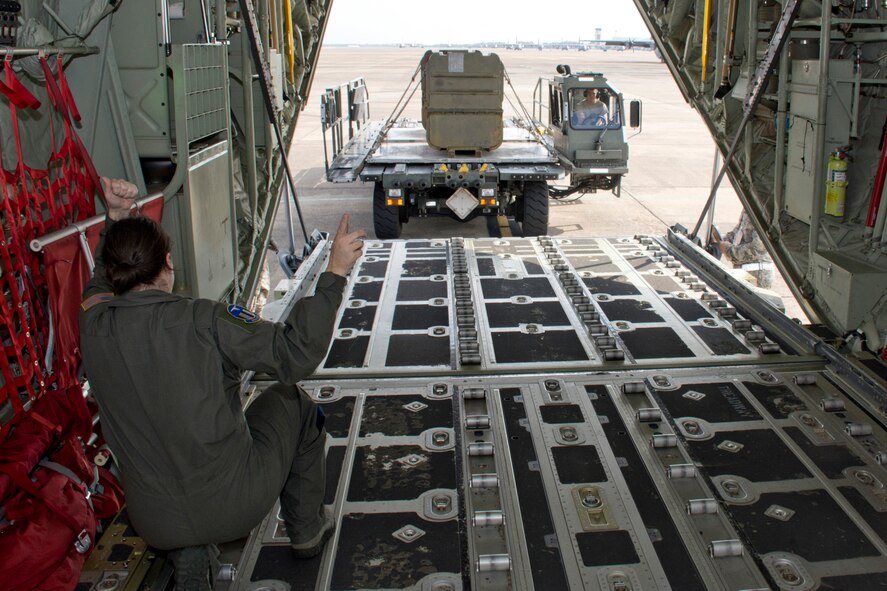 U.S. Air Force Reserve Tech. Sgt. Aja Ledbetter, loadmaster, 327th Airlift Squadron, directs the operator of a military aircraft cargo K loader during a training evolution at Little Rock Air Force Base, Ark., Oct. 16, 2016. Loadmasters are trained on how to load various configurations of cargo onto the aircraft and secure them for transportation around the world. (U.S. Air Force photo by Master Sgt. Jeff Walston/Released)