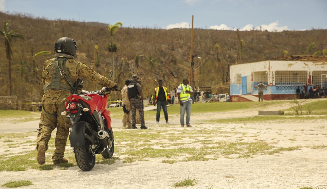 U.S. Army Sgt. King David, a crew chief with Joint Task Force - Bravo's 1st Battalion, 228th Aviation Regiment, delivers a motorcycle to the local police force at Jeremie, Haiti, Oct. 9, 2016. The Marines with Special Purpose Marine Air-Ground Task Force - Southern Command and soldiers with JTF-Bravo are part of Joint Task Force Matthew, a U.S. Southern Command-directed team deployed to Port-au-Prince at the request of the Government of Haiti, on a mission to provide humanitarian and disaster relief assistance in the aftermath of Hurricane Matthew. (U.S. Marine Corps photo by Cpl. Samuel Guerra)