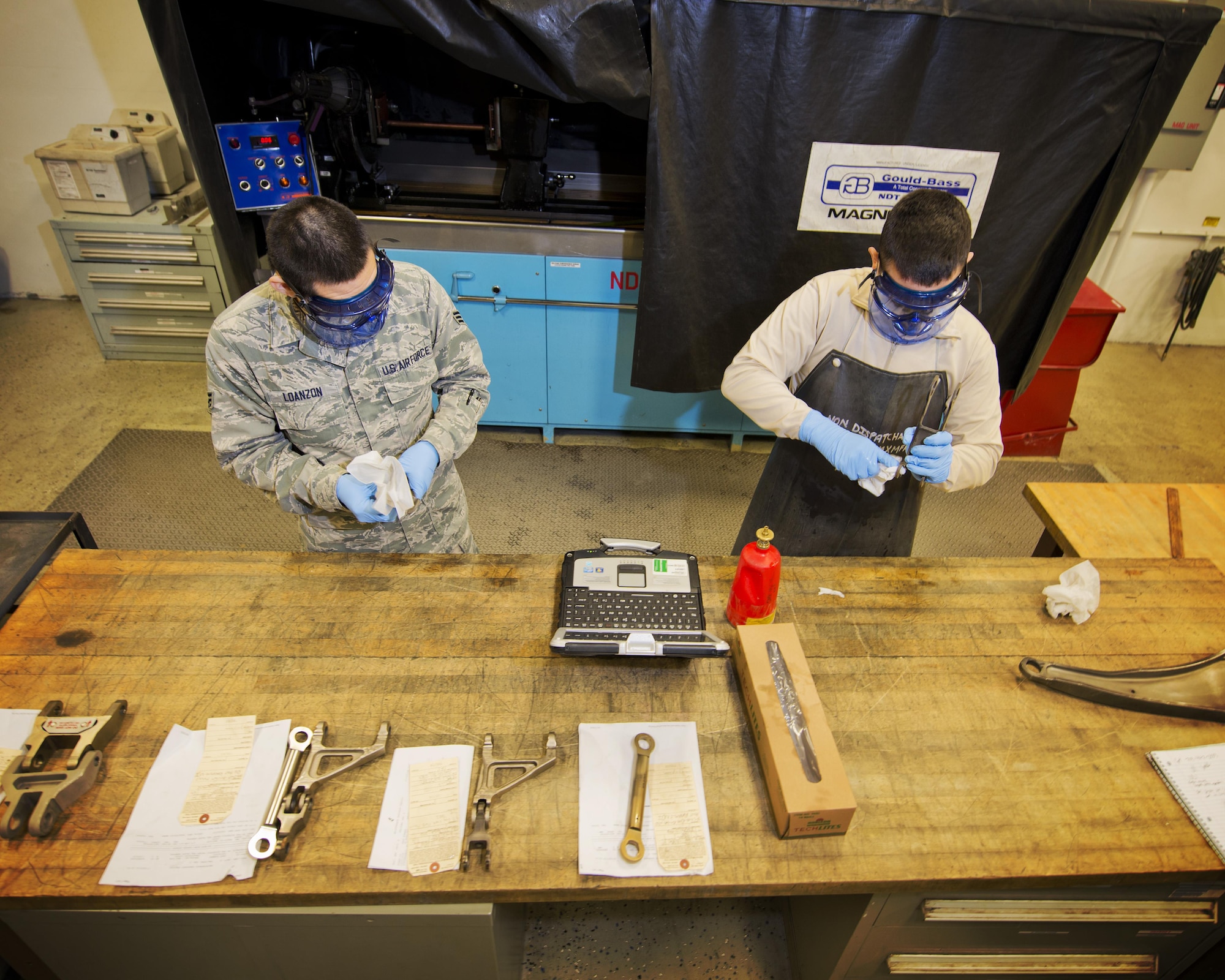 Airmen from the 5th Aircraft Maintenance Squadron clean grease from aircraft parts before a magnetic particle inspection at Minot Air Force Base, N.D., Oct. 18, 2016. All debris and grease are removed to prevent contamination of the particle bath during the inspection process. (U.S. Air Force photo/Airman 1st Class J.T. Armstrong)