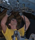 Staff Sgt. Alex Jimenez, 5th Aircraft Maintenance Squadron weapons load crew member, works on a B-52H Stratofortress during a bomb load competition at Minot Air Force Base, N.D., Oct. 14, 2016.  As part of the Minot AFB Weapons Load Crew of the Quarter Competition, the 5 AMXS was timed on their ability to complete a loading process efficiently. (U.S. Air Force photo/Airman 1st Class Jonathan McElderry)