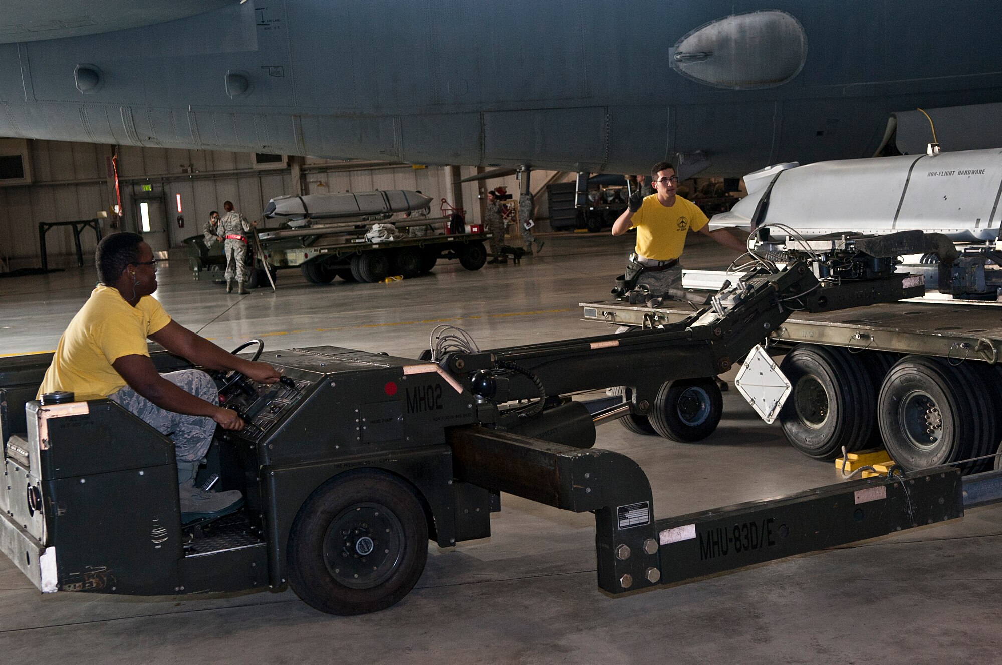 (Left to right) Senior Airman Gerald Kimeu, left, and Staff Sgt. Alex Jimenez, 5th Aircraft Maintenance Squadron weapons load crew members, move an inert munition during a bomb load competition at Minot Air Force Base, N.D., Oct. 14, 2016. Load crew members must maintain proficiency in 17 different types of munitions. (U.S. Air Force photo/Airman 1st Class Jonathan McElderry)