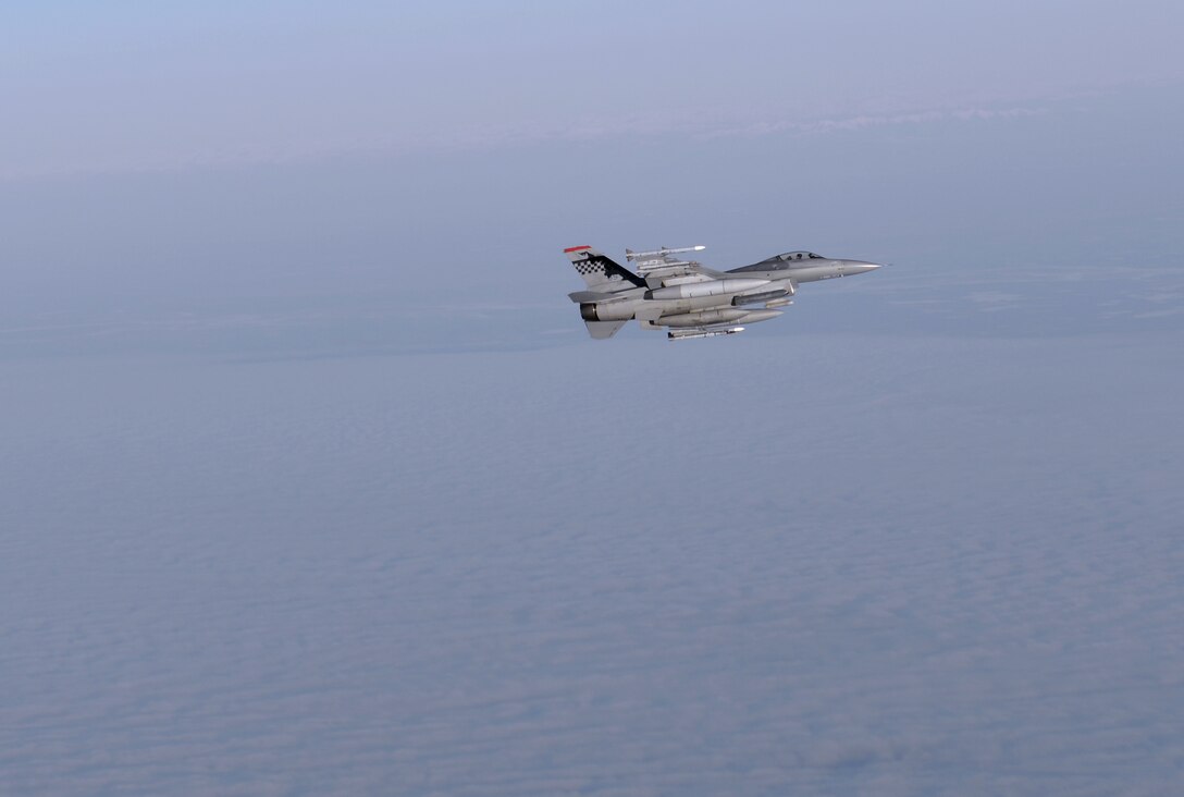 A U.S. Air Force F-16 Fighting Falcon assigned to the 36th Fighter Squadron out of Osan Air Base, Republic of Korea, flies in formation next to a KC-135 Stratotanker aircraft while waiting to refuel Oct. 10, 2016, during a RED FLAG-Alaska (RF-A) 17-1 mission. RF-A is a series of Pacific Air Forces commander-directed field training exercises conducted within the Joint Pacific Alaska Range Complex, which provides a realistic training environment and allows commanders to train for full spectrum engagements ranging from individual skills to complex, large-scale joint missions. (U.S. Air Force photo by Master Sgt. Karen J. Tomasik)