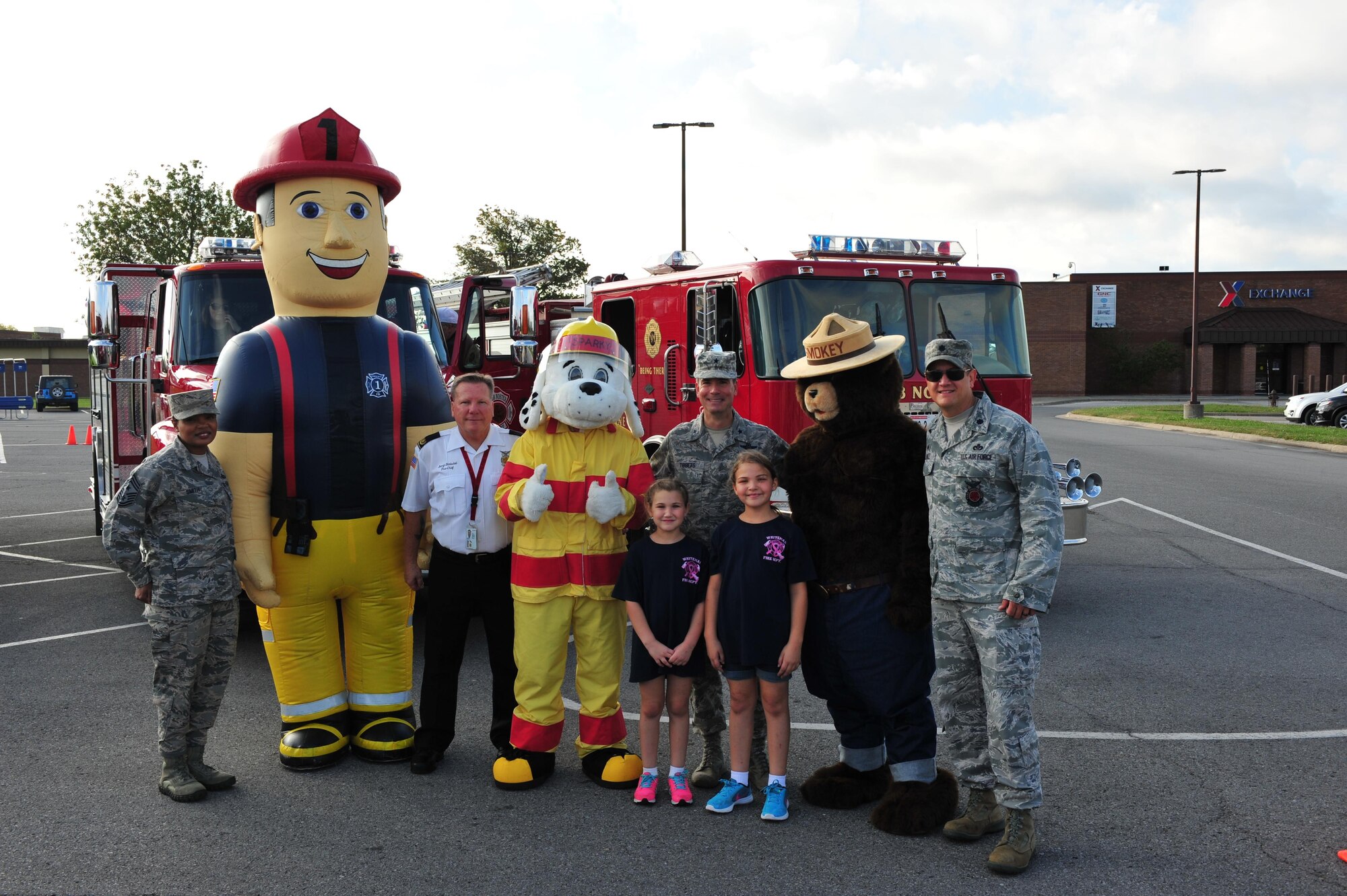 Members of Team Whiteman gather for a group photo prior to the start of the fire prevention finale parade at Whiteman Air Force Base, Mo., Oct. 15, 2016. Fire prevention week is an annual event recognizing fire safety hazards and ways to prevent them from happening. (U.S. Air Force photo by Senior Airman Jovan Banks)