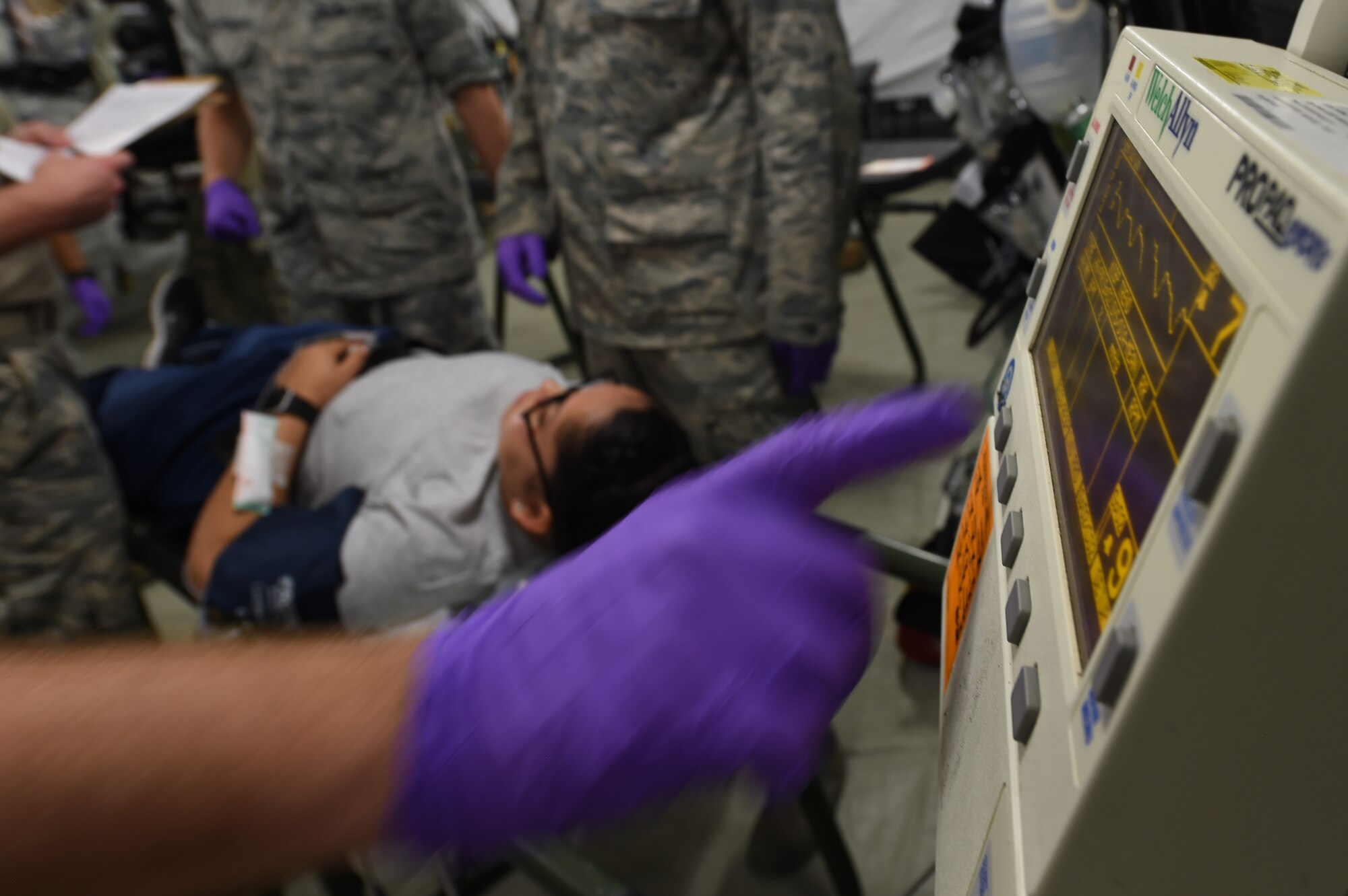 An emergency room technician checks a patients vitals during the 633rd Medical Group’s global response force training exercise at Joint Base Langley-Eustis, Va., Oct. 20, 2016. In a real-world global response scenario the field hospital, the medical group trained in, can provide care for a population of 6,500. (U.S. Air Force photo by Staff Sgt. Natasha Stannard)