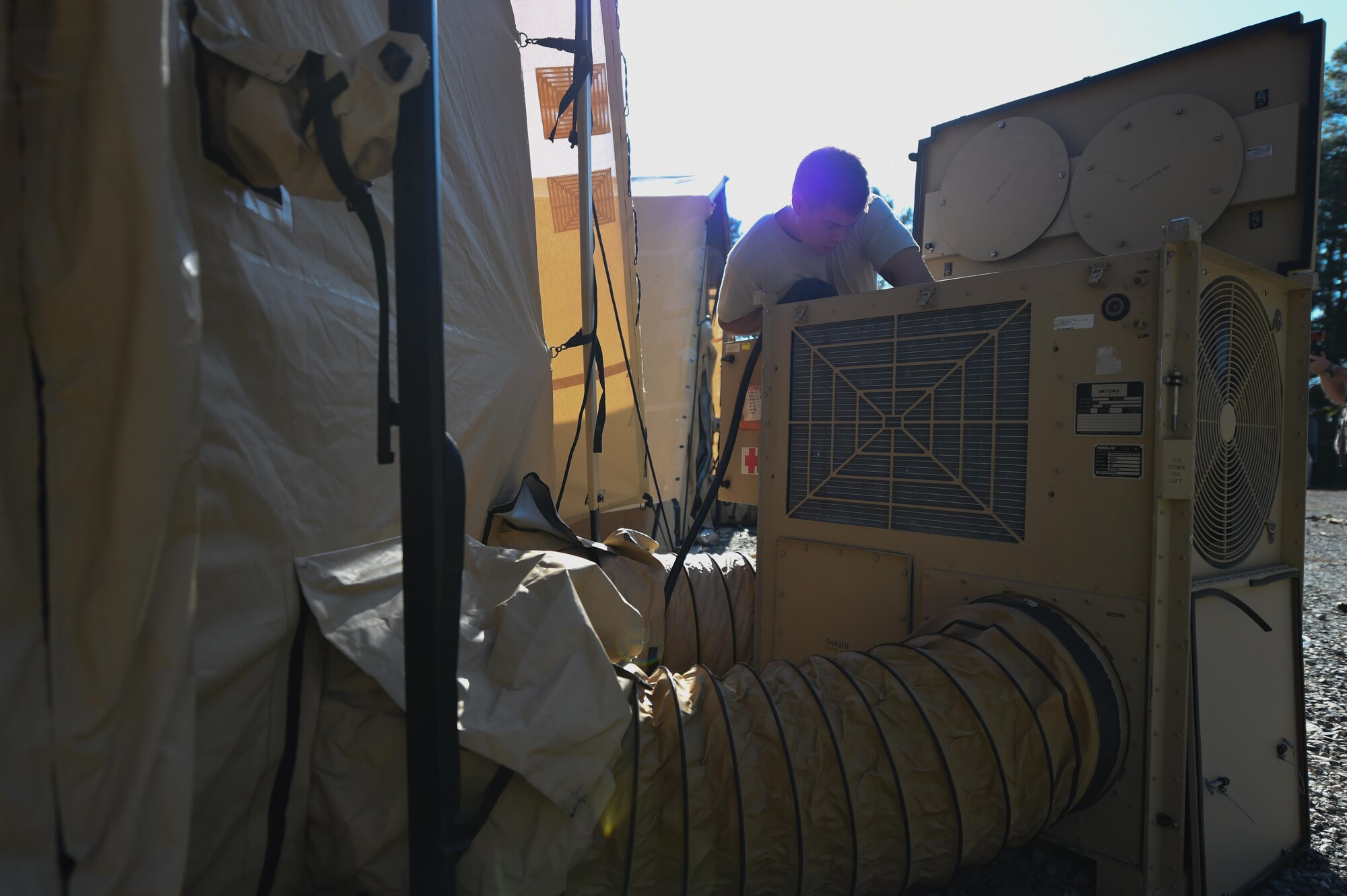 U.S. Air Force Senior Airman Shane Posey, 633rd Medical Support Squadron biomedical equipment technician, checks an air conditioning system during a medical global response force training exercise at Joint Base Langley-Eustis, Va., Oct. 19, 2016. Upon arriving to a global response force mission, technicians must have the field hospital up and running within 60 hours. (U.S. Air Force photo by Staff Sgt. Natasha Stannard)