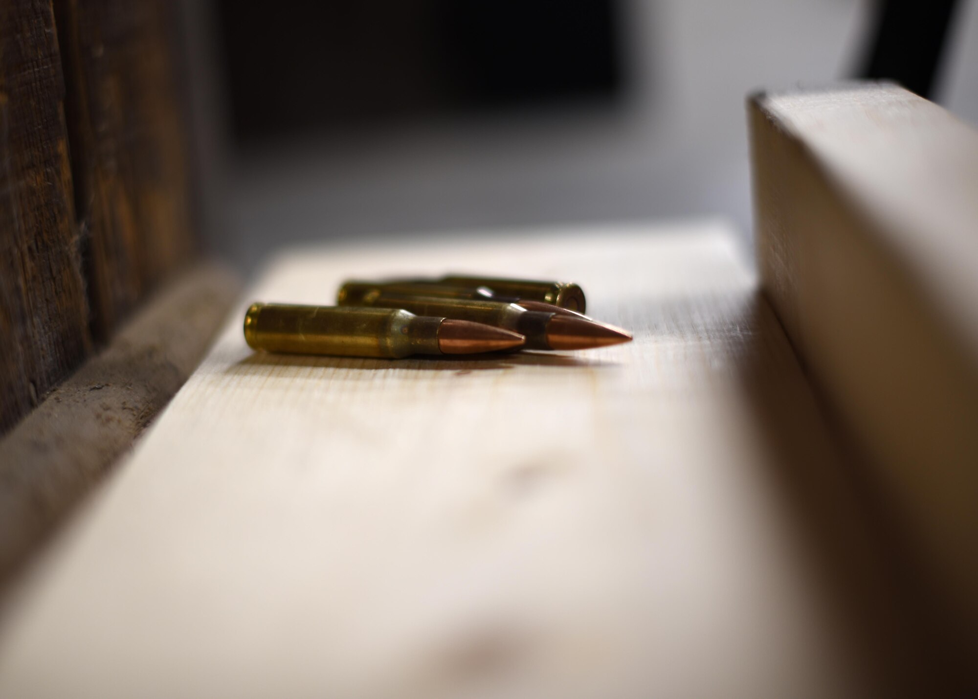 A few 5.56-millimeter NATO rounds lie on the ground of the firing range Oct. 21, 2016, on Grand Forks Air Force Base, N.D. The newly-renovated range has concrete floors that will allow all fired and live rounds to be properly disposed of better than when there were gravel floors. (U.S. Air Force photo by Senior Airman Ryan Sparks)