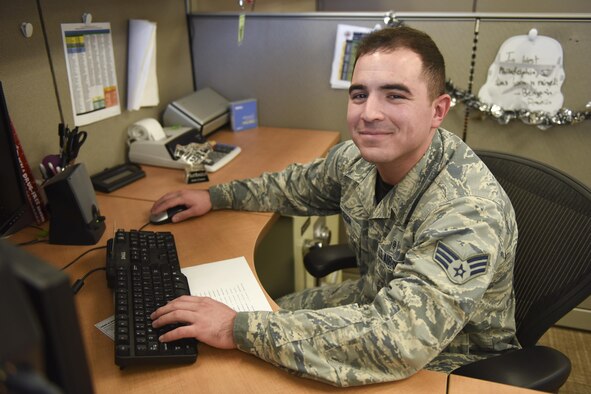 U.S. Air Force Senior Airman Stephen Muldoon, 17th Medical Support Squadron resource management office technician, sits at his desk at the Medical Administration Building on Goodfellow Air Force Base, Oct. 21, 2016. Muldoon was awarded the Phil Neighbors Community Impact Award for his outstanding contributions to the community. (U.S. Air Force photo by Airman 1st Class Chase Sousa/Released)