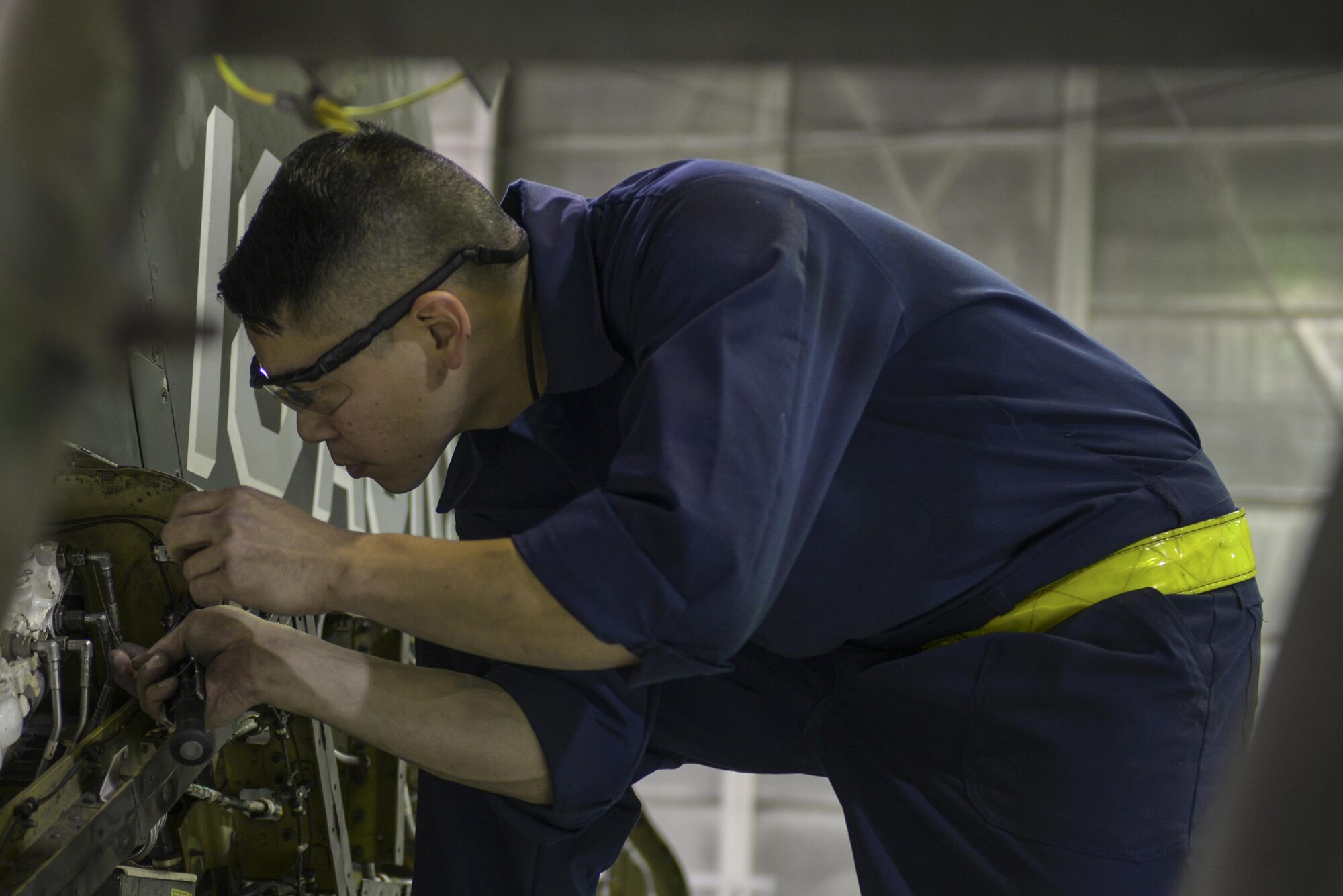 U.S. Air Force Senior Airman Danny Navo, a 354th Maintenance Squadron phase inspection section apprentice, works on the rudder of an F-16 Fighting Falcon aircraft Oct. 6, 2016, at Eielson Air Force Base, Alaska. Navo is preparing to take the rudder off. (U.S. Air Force photo by Airman Isaac Johnson)