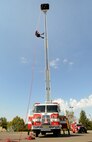 The ladder truck was utilized during Fire Prevention Week to demonstrate rope rescue drills and provide practice and training for fire department personnel. (Air Force photo by Kelly White)