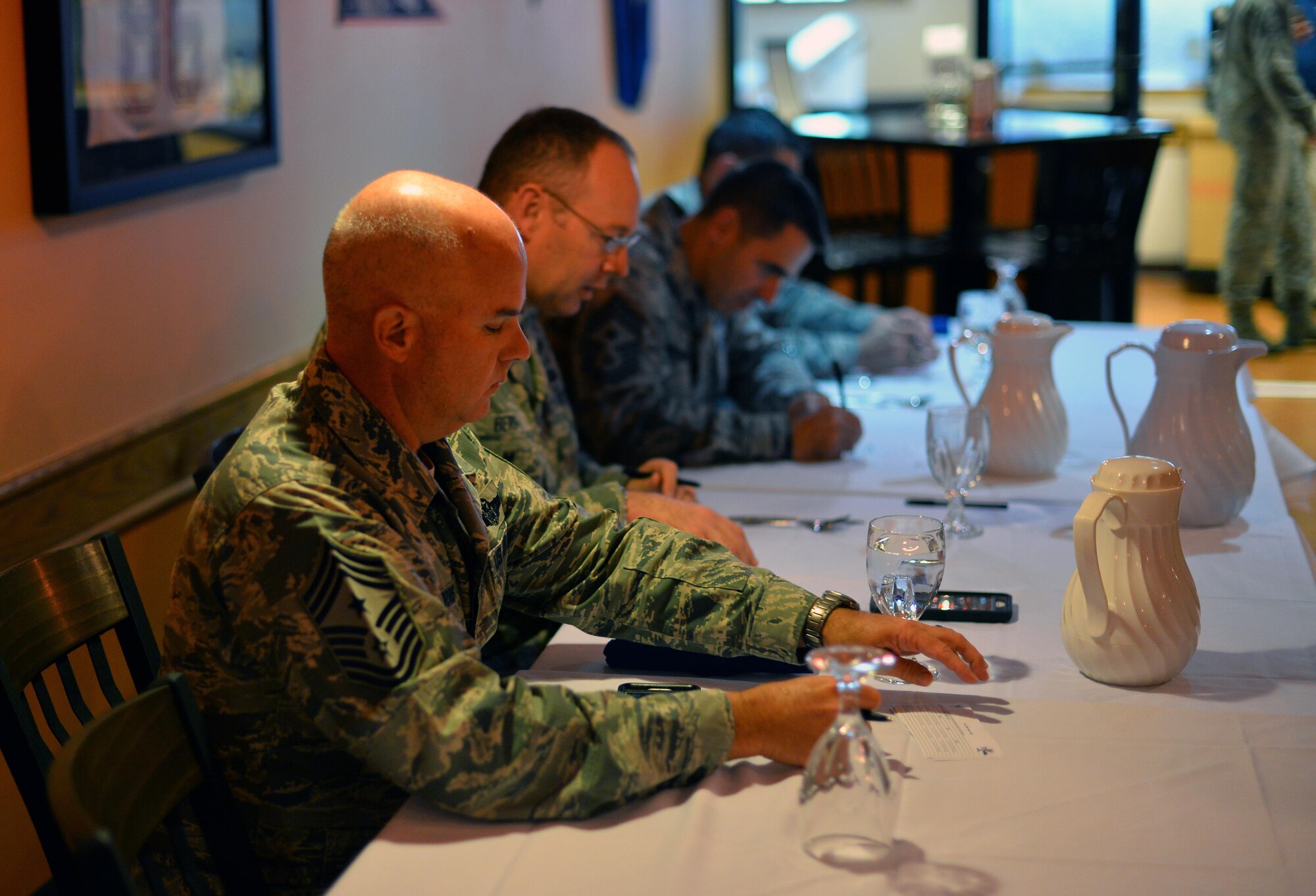 U.S. Air Force Command Chief Master Sgt. Michael Morris, 55th Wing command chief, looks over his scoring card that he’ll use to judge dishes presented to him by 55th Force Support Squadron food service specialists competing in the Iron Chef Grill Masters competition at the Ronald L. King Dining Facility Oct 13, Offutt Air Force Base, Neb.  Each team was to present three dishes to be critiqued by a panel of wing leadership.  (U.S. Air Force photo by Josh Plueger)