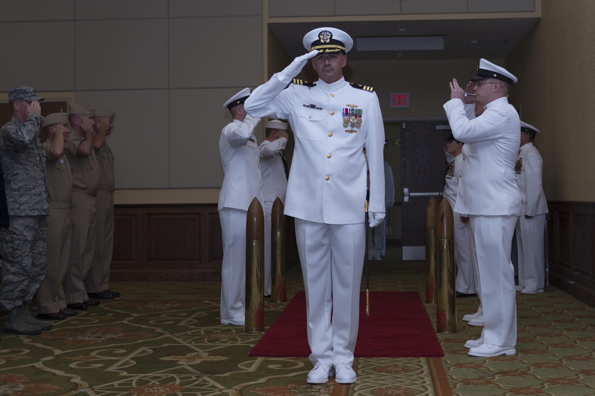 U.S. Navy Cmdr. Timothy Knapp, incoming Center for Naval Aviation Technical Training Unit Keesler commanding officer, renders a salute as he enters the CNATTU Keesler change of command ceremony at the Bay Breeze Event Center Oct. 20, 2016, on Keesler Air Force Base, Miss. Knapp was previously the executive officer at the Fleet Weather Center, Norfolk, Va. (U.S. Air Force photo by Andre’ Askew/Released)
