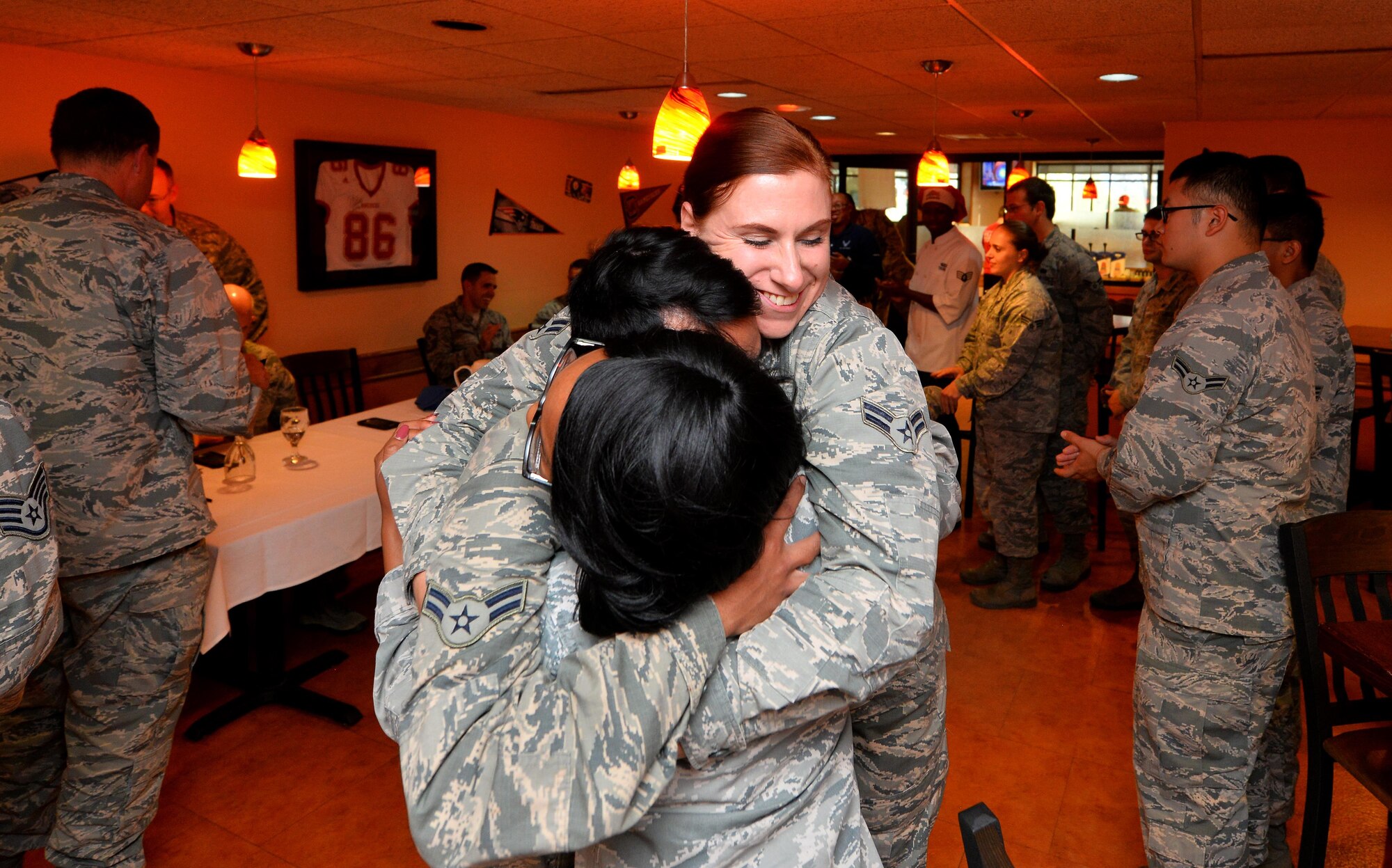 The Iron Chef team representing the Campisi Alert Dining Facility embrace in a team hug as they were voted the winner of the Iron Chef Grill Masters competition held held at the Ronald L. King Dining Facility on Oct. 13, Offutt Air Force Base, Neb.  Each team had to use three of the secret ingredients: kiwi, mushrooms and pineapple.  (U.S. Air Force photo by Josh Plueger)