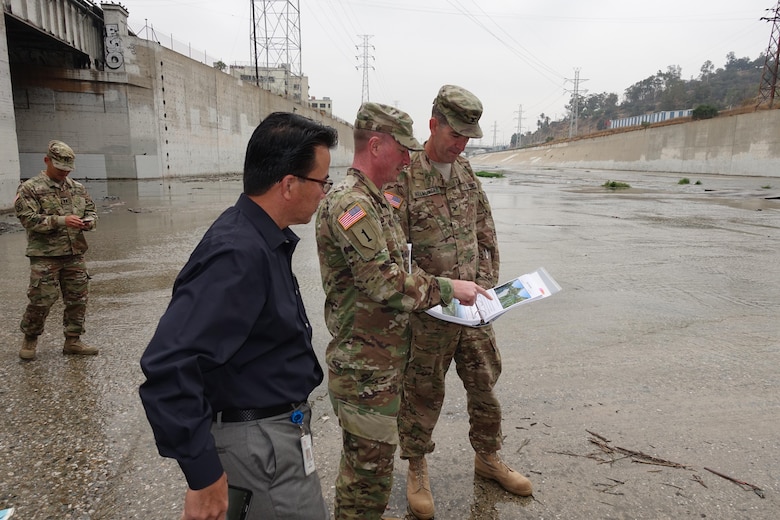 U.S. Army Corps of Engineers South Pacific Division Commander Col. Pete Helmlinger visited various project sites during his week-long visit to the Los Angeles District. Here, District Commander Col. Kirk Gibbs (center) briefs the complexity of the Los Angeles River Ecosystem Restoration as they stand in the river where it's joined by the Arroyo Seco Confluence Oct. 12.