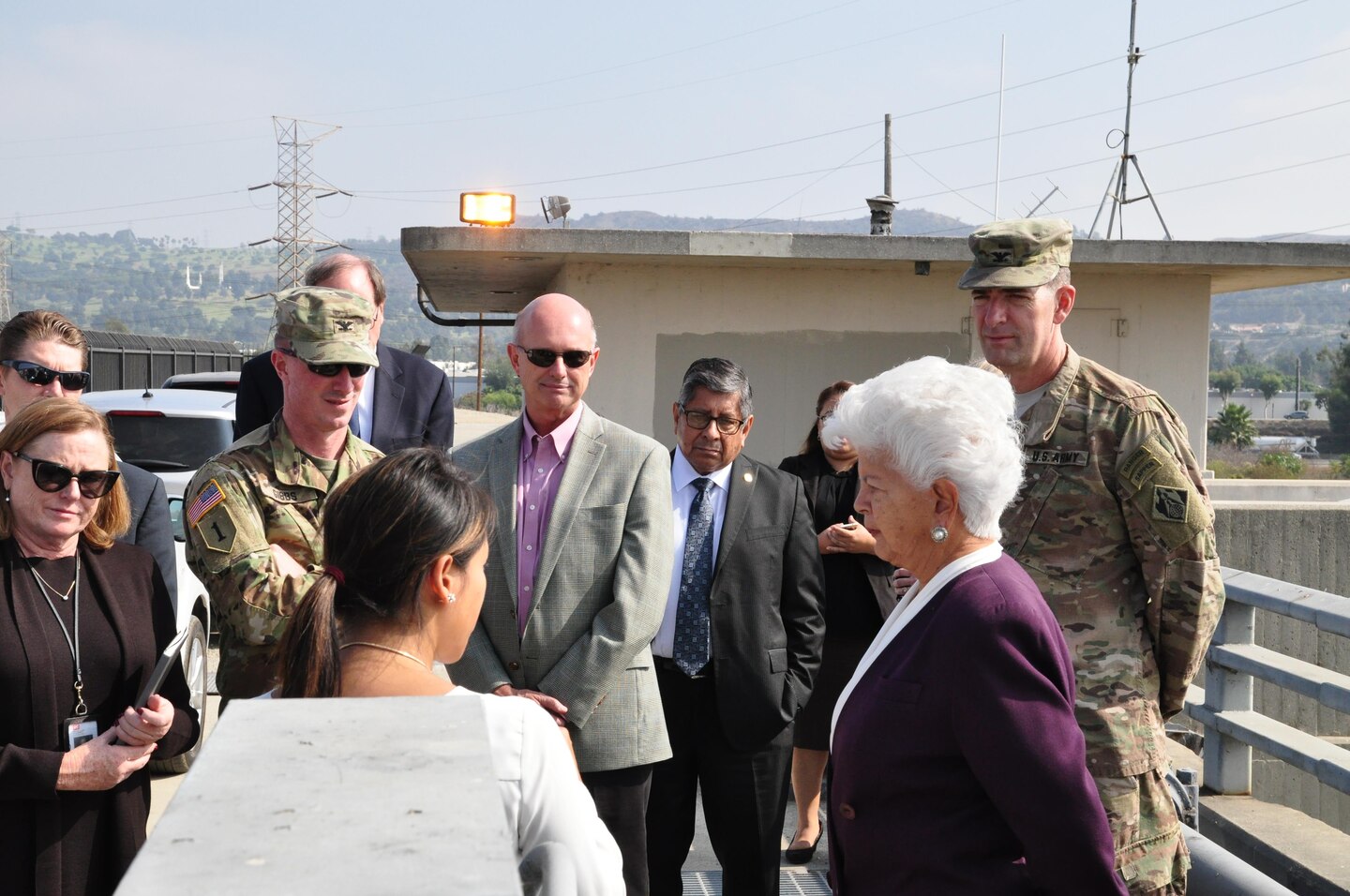 Lillian Doherty (center foreground), chief of Operations Division, briefs Rep. Grace Napolitano on the operation of control gates along the San Gabriel River side of Whittier Narrows Dam during Col. Helmlinger’s October 12 visit to the dam. Concerns about premature opening of the gates under certain conditions are a factor in the dam’s recently increased safety classification.