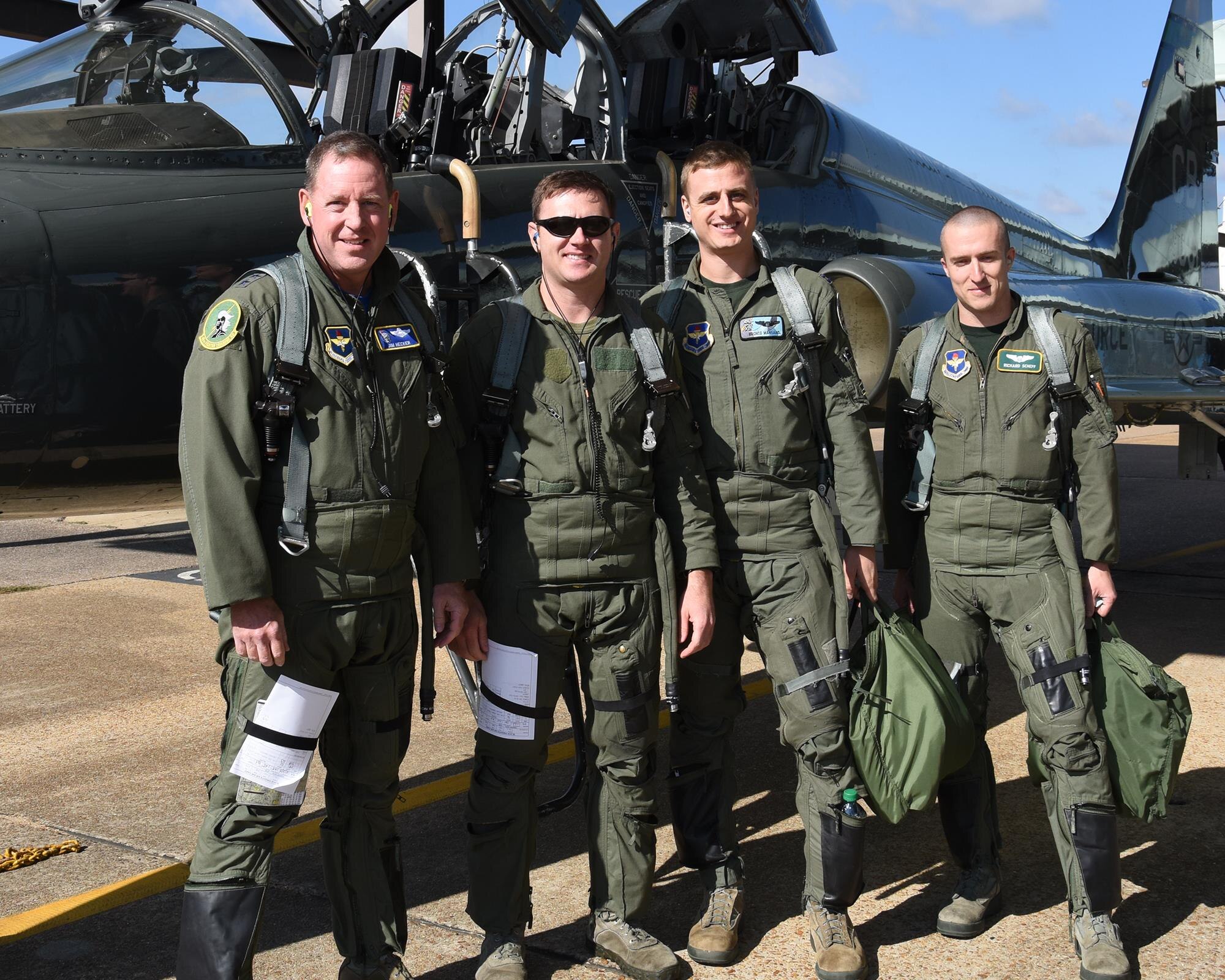 Maj. Gen. James Hecker, 19th Air Force Commander, poses for a photo with Maj. Caleb Campbell, 49th Fighter Training Squadron Instructor Pilot, Capt. Michael Mangano, 49th FTS IP, and 2nd Lt. Richard Scheff, 49th FTS student, Oct. 21, 2016, on the flight line on Columbus Air Force Base, Mississippi. Hecker toured the 14th Flying Training Wing and went for a ride in a T-38C Talon student sortie for Introduction to Fighter Fundamentals. (U.S. Air Force photo by Elizabeth Owens)